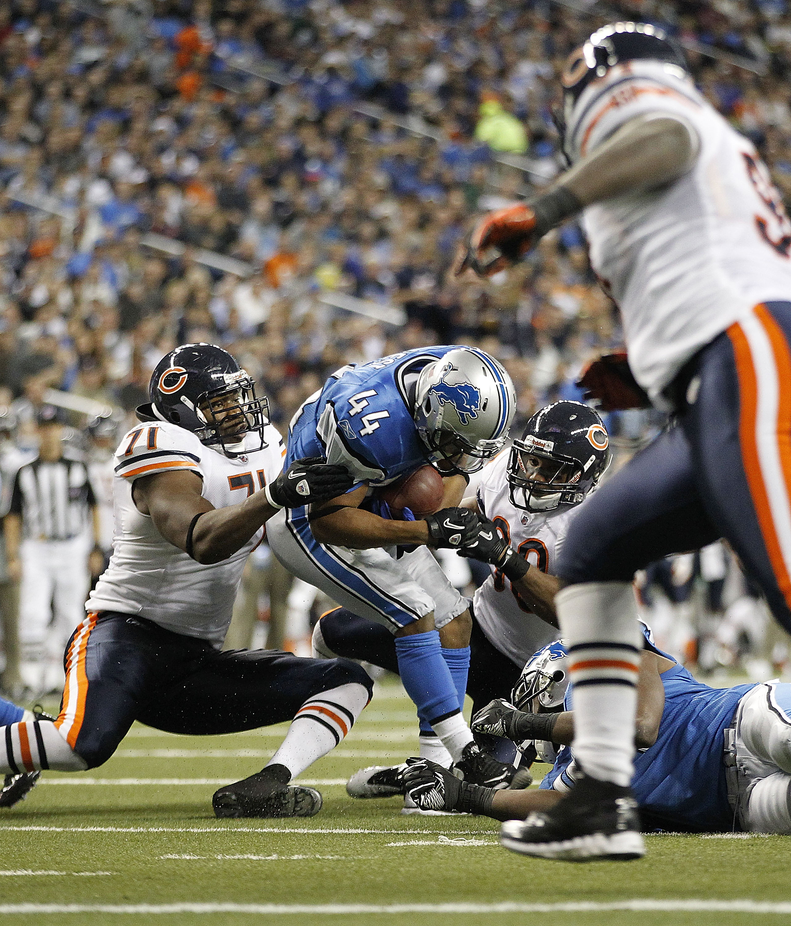 DETROIT - DECEMBER 05: Israel Idonije #71 and Danieal Manning #38 of the Chicago Bears make the stop on Jahvid Best #44 of the Detroit Lions during the third quarter of the game at Ford Field on December 5, 2010 in Detroit, Michigan. The Bears defeated th