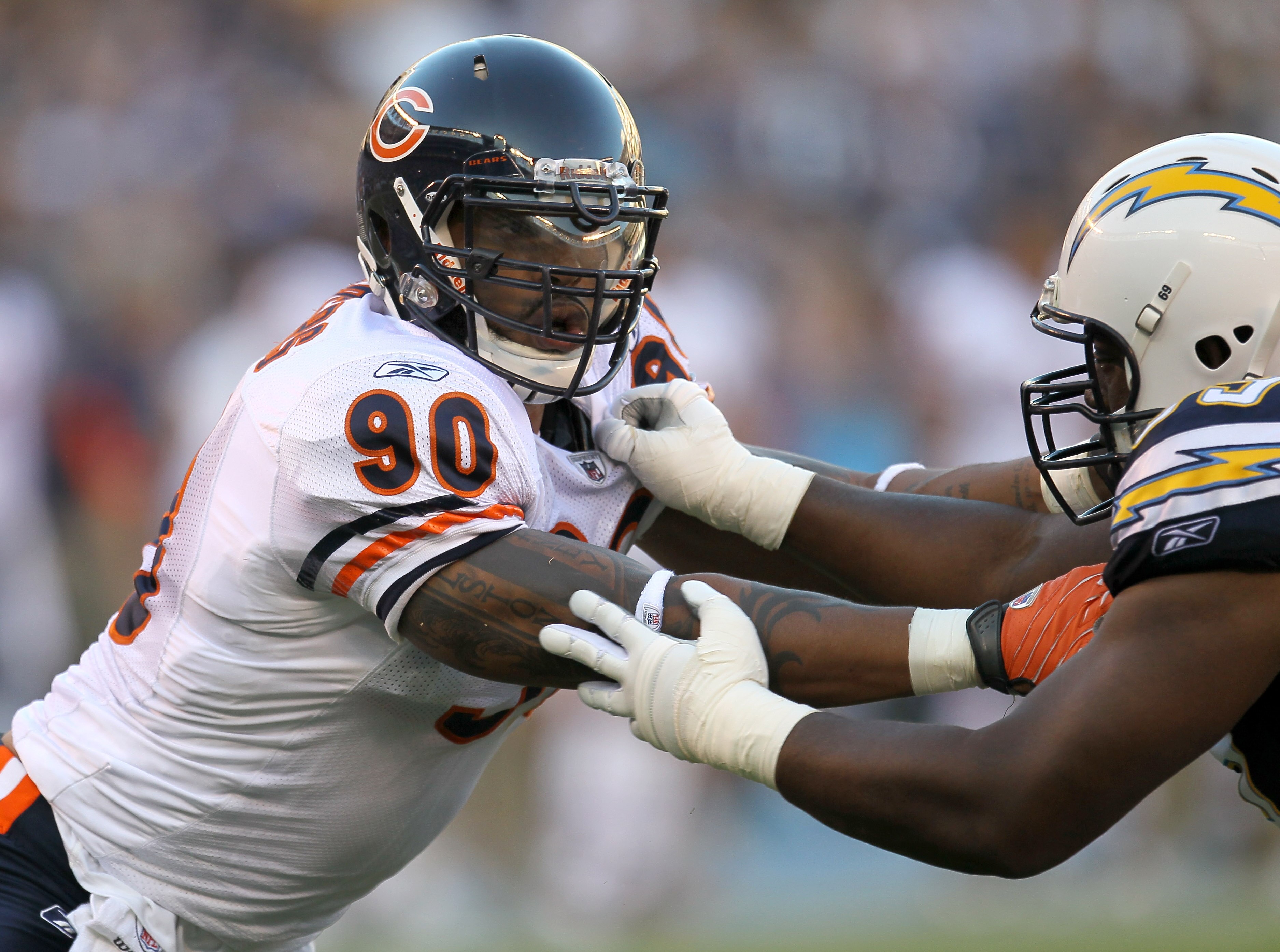SAN DIEGO - AUGUST 14:  Defensive end Julius Peppers #90 of the Chicago Bears battles offensive guard Tyronne Green #69 of the San Diego Chargers on August 14, 2010 at Qualcomm Stadium in San Diego, California.  (Photo by Stephen Dunn/Getty Images)