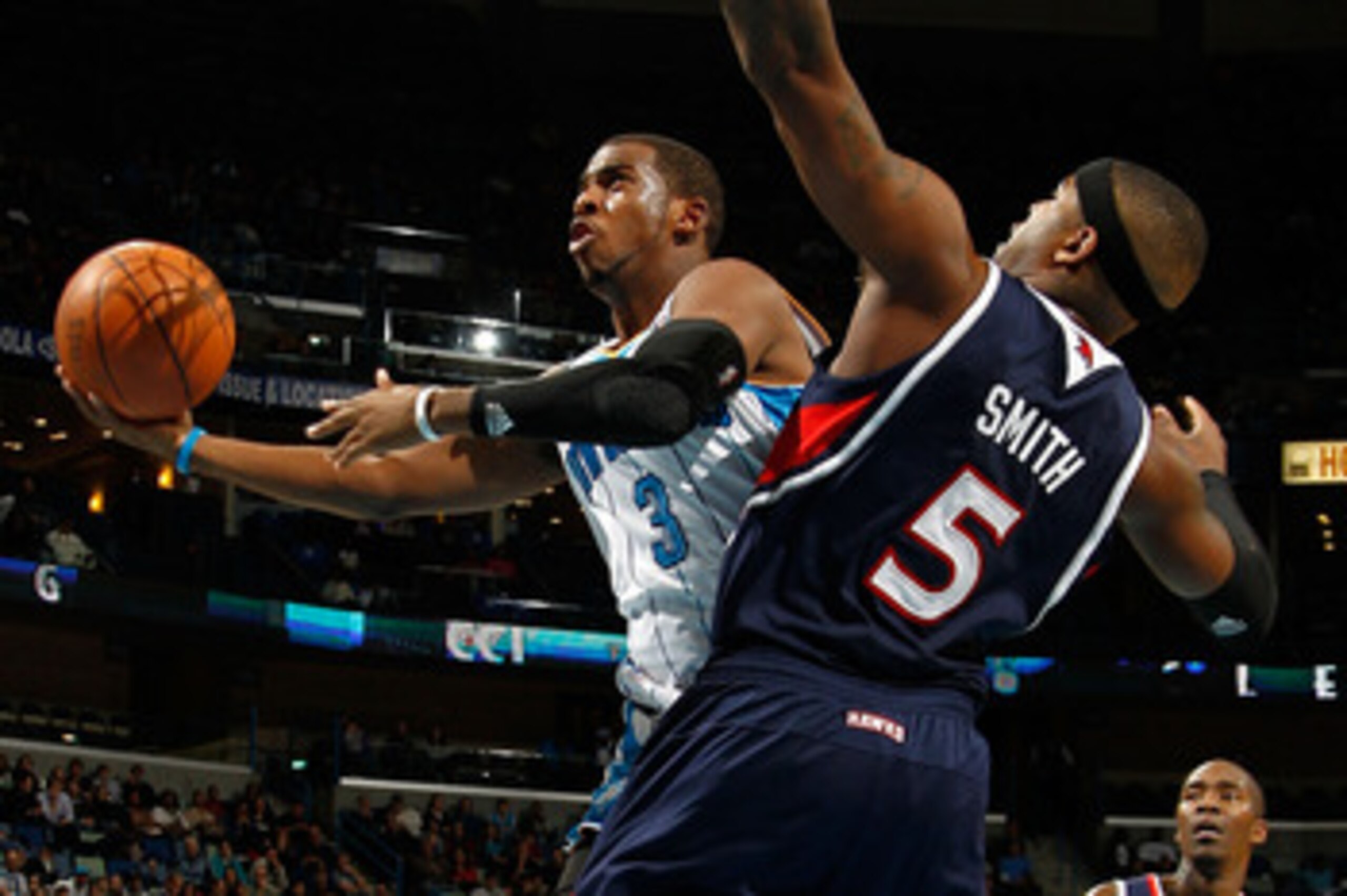 NEW ORLEANS, LA - DECEMBER 26:  Chris Paul #3 of the New Orleans Hornets shoots the ball over Josh Smith #5 of the Atlanta Hawks at the New Orleans Arena on December 26, 2010 in New Orleans, Louisiana.  NOTE TO USER: User expressly acknowledges and agrees