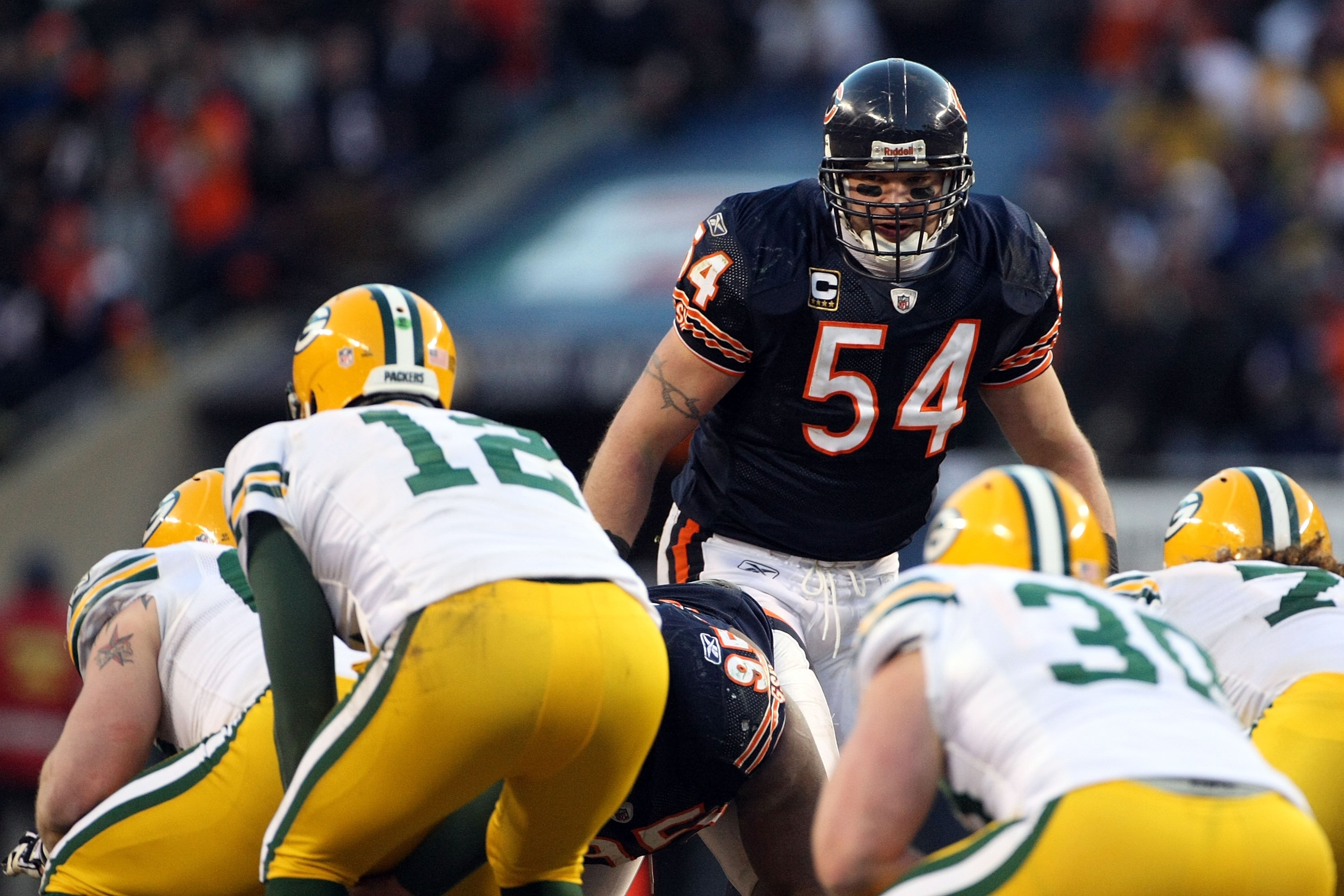 CHICAGO, IL - JANUARY 23:  Brian Urlacher #54 of the Chicago Bears looks over at Aaron Rodgers #12 of the Green Bay Packers before the snap in the NFC Championship Game at Soldier Field on January 23, 2011 in Chicago, Illinois.  (Photo by Doug Pensinger/G