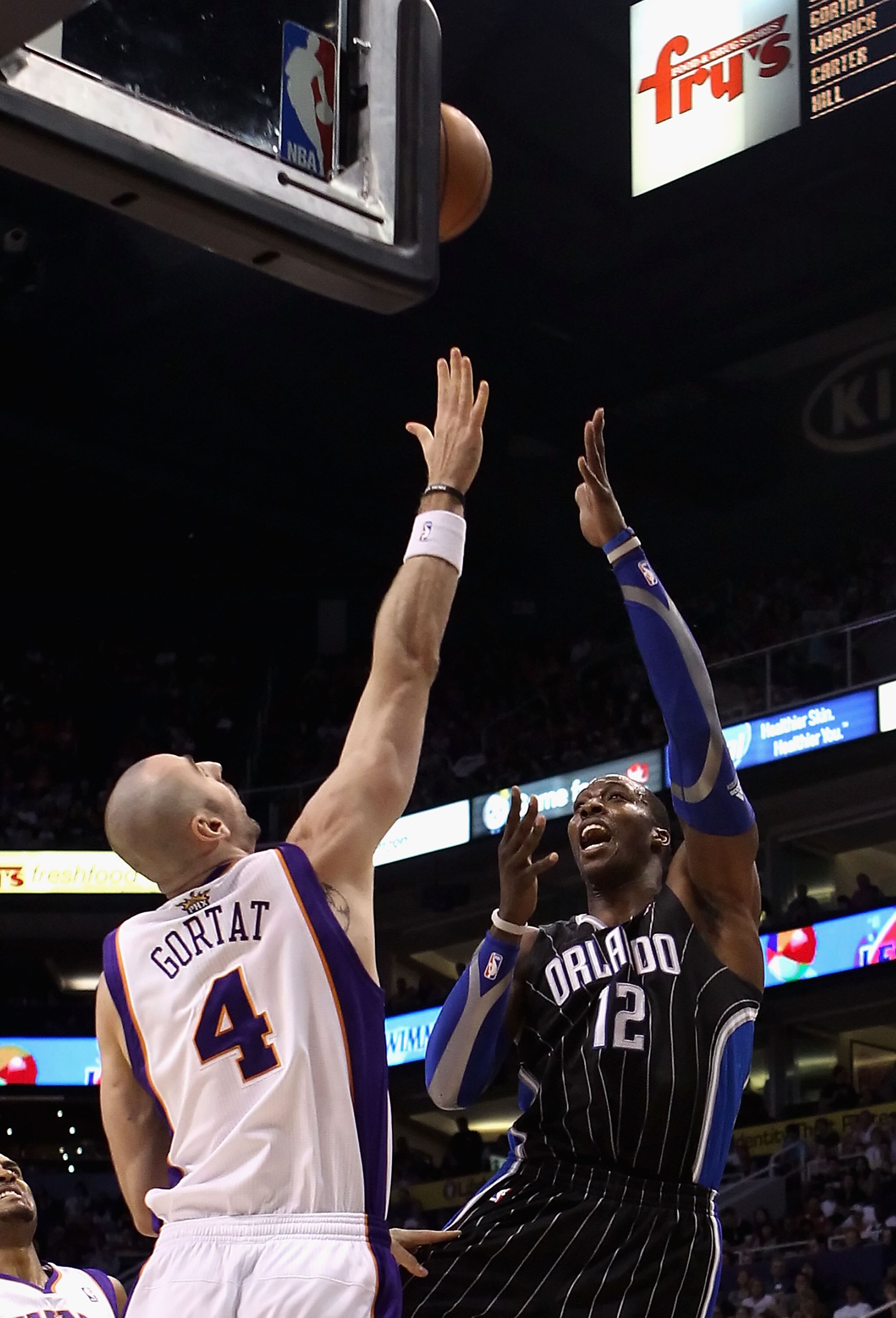 PHOENIX, AZ - MARCH 13:  Dwight Howard #12 of the Orlando Magic puts up a shot during the NBA game against the Phoenix Suns at US Airways Center on March 13, 2011 in Phoenix, Arizona. The Magic defeated the Suns 111-88. NOTE TO USER: User expressly acknow