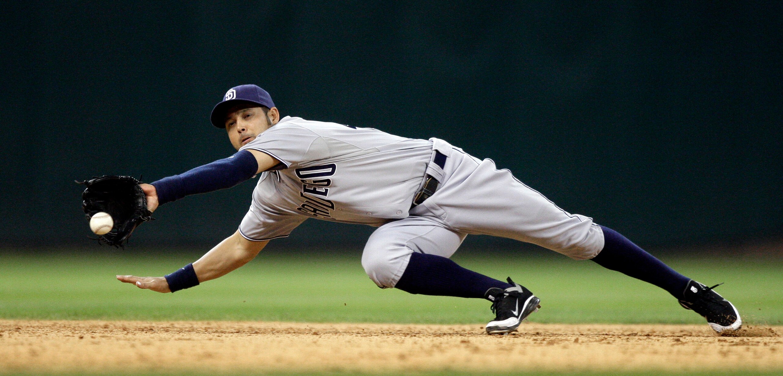 HOUSTON - APRIL 15:  Shortstop Jason Bartlett #8 of the San Diego Padres makes a diving catch against the Houston Astros at Minute Maid Park on April 15, 2011 in Houston, Texas.  (Photo by Bob Levey/Getty Images)