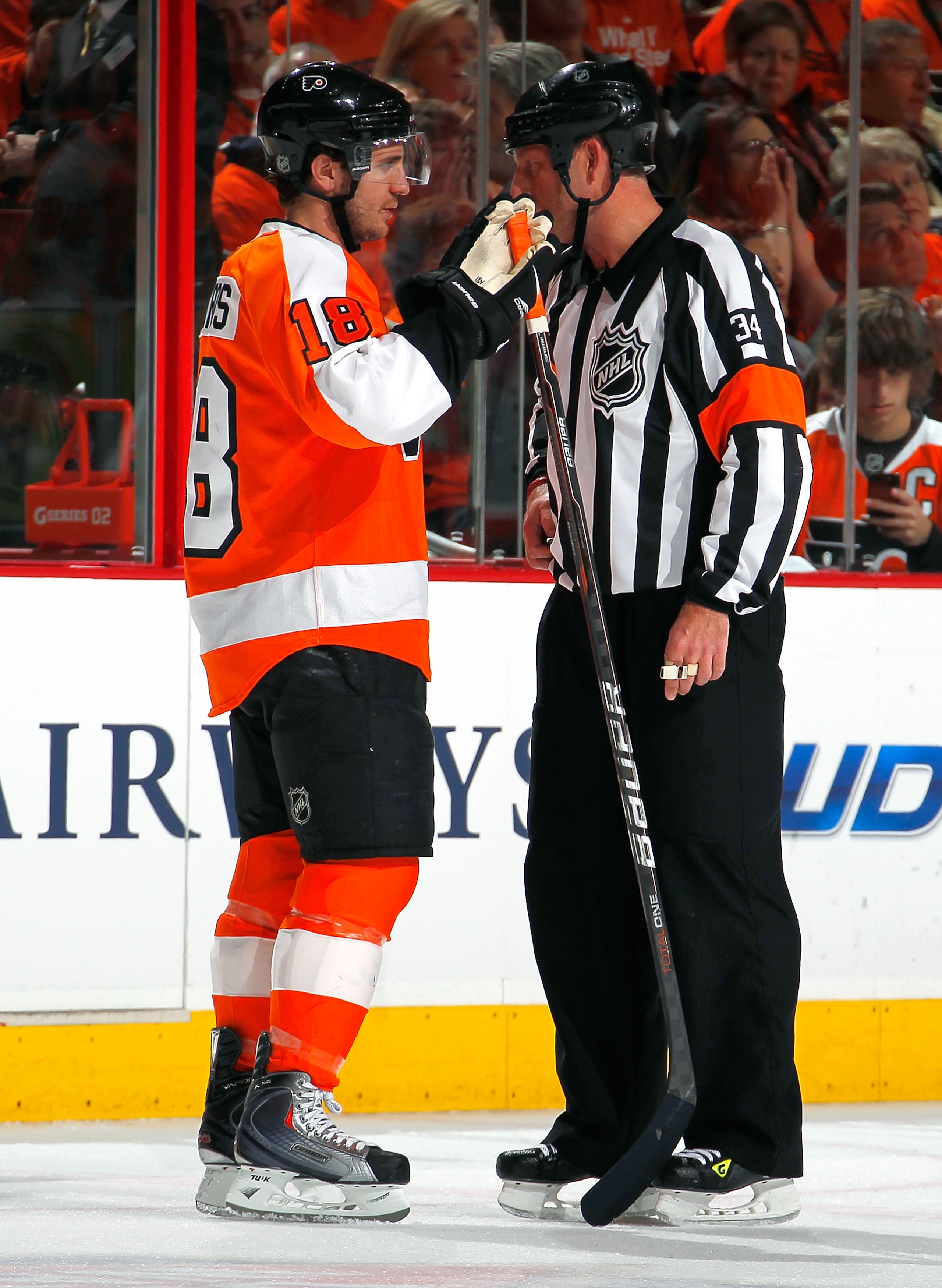PHILADELPHIA, PA - APRIL 16:  Mike Richards #18 of the Philadelphia Flyers talks with referee Brad Meier #34 in Game Two of the Eastern Conference Quarterfinals against the Buffalo Sabres during the 2011 NHL Stanley Cup Playoffs at Wells Fargo Center on A