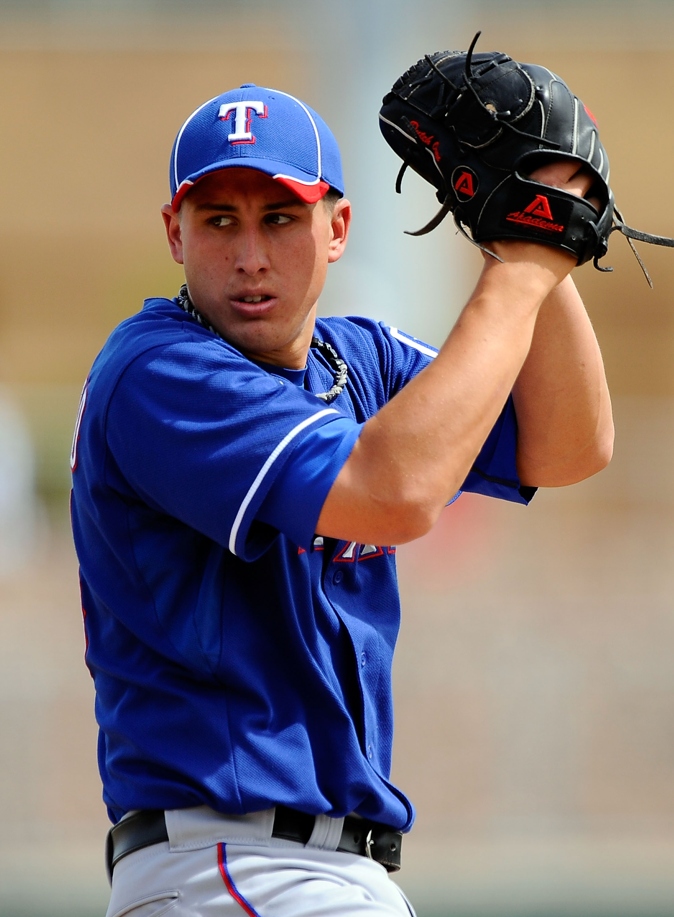 GLENDALE, AZ - MARCH 15:  Pitcher Derek Holland #45 of the Texas Rangers  throws a pitch against the Los Angeles Dodgers during the spring training baseball game at Camelback Ranch on March 15, 2011 in Glendale, Arizona.  (Photo by Kevork Djansezian/Getty