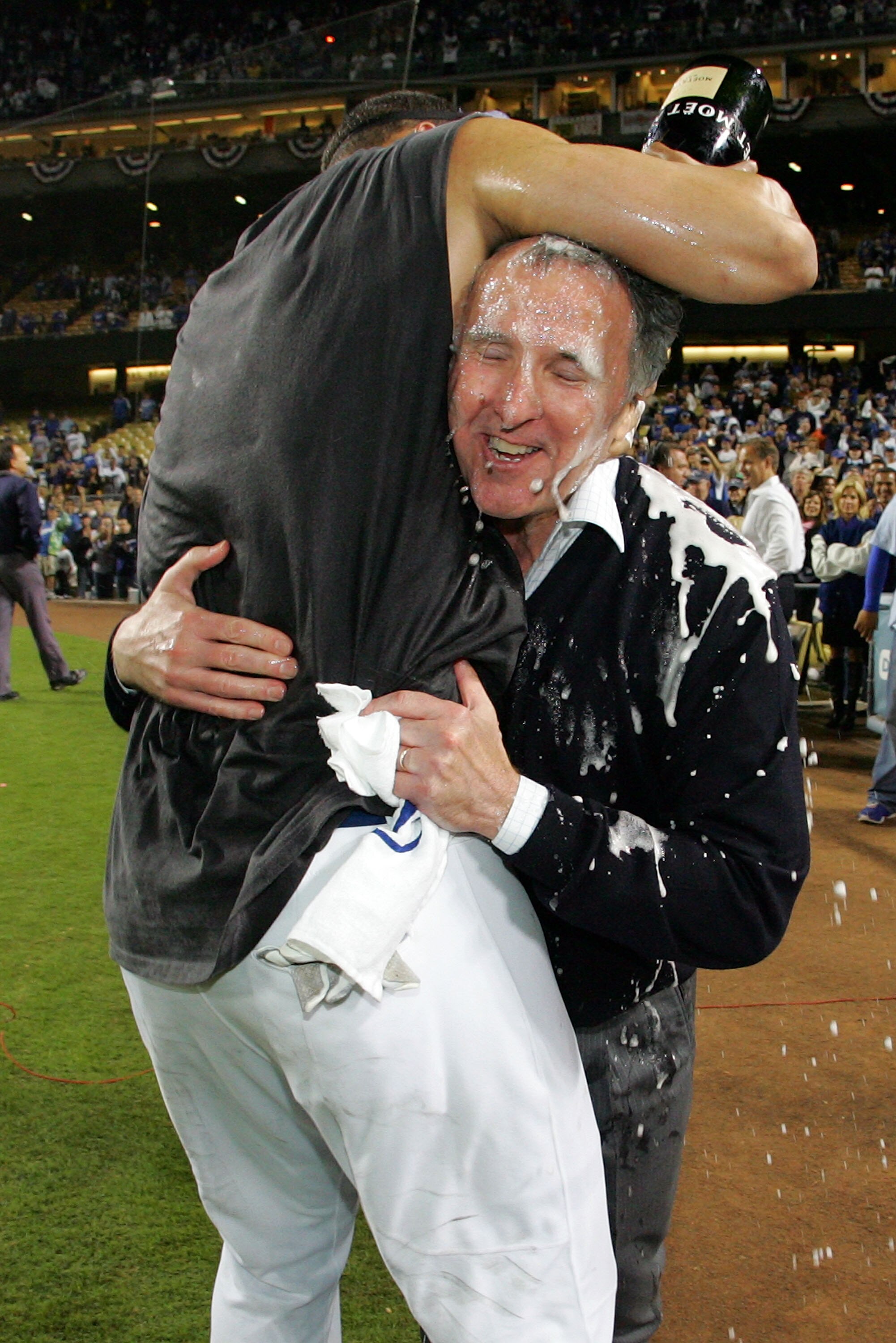 LOS ANGELES, CA - OCTOBER 04:  (L) Matt Kemp #27 pours champagne on owner Frank McCourt of the Los Angeles Dodgers as they celebrate after defeating the Chicago Cubs in Game Three of the NLDS during the 2008 MLB playoffs on October 4, 2008 at Dodger Stadi