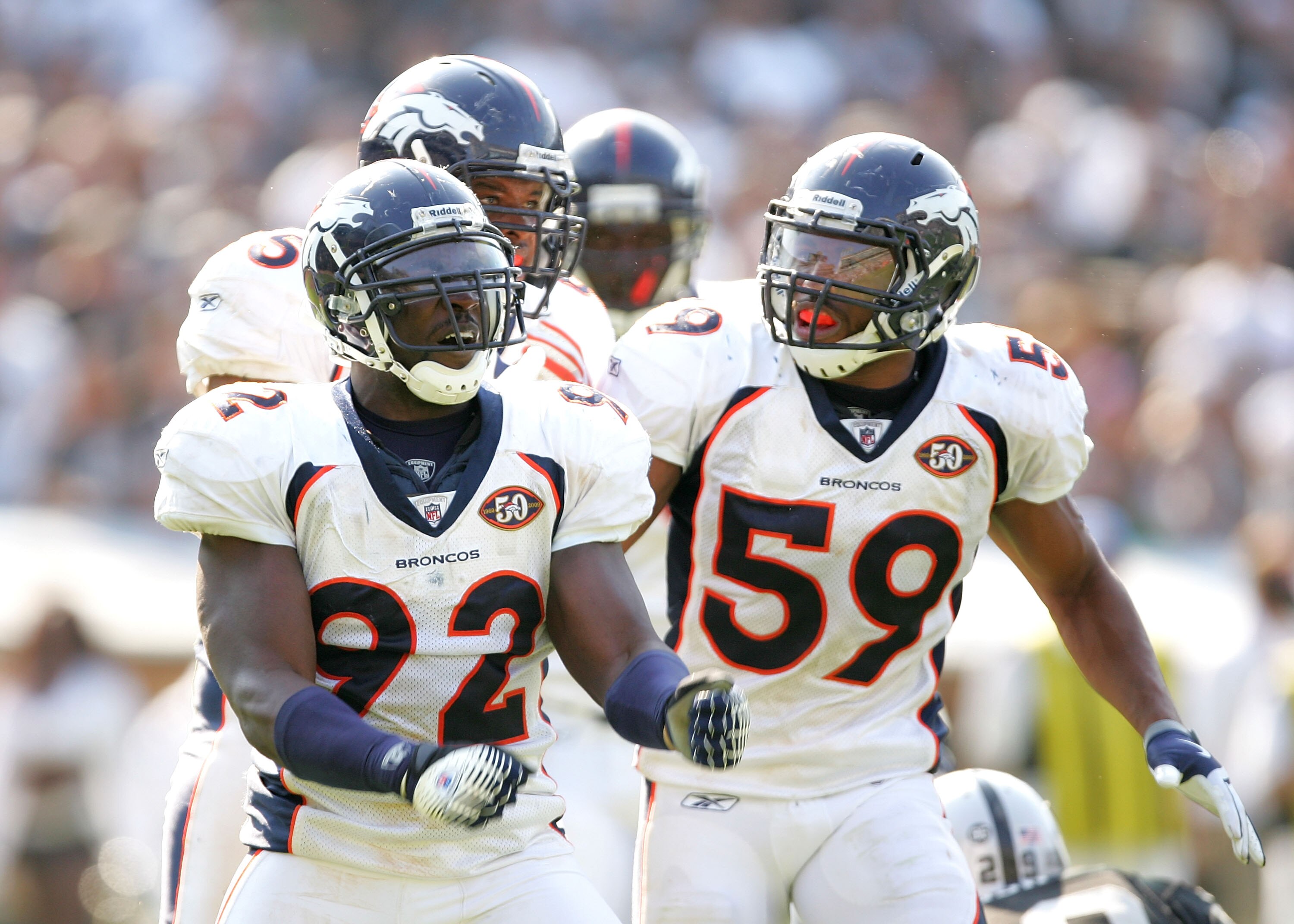 OAKLAND, CA - SEPTEMBER 27:   Wesley Woodyard #59 congratulates Elvis Dumervil #92 of the Denver Broncos after Dumervil sacked JaMarcus Russell of the Oakland Raiders at the Oakland-Alameda County Coliseum on September 27, 2009 in Oakland, California.  (P