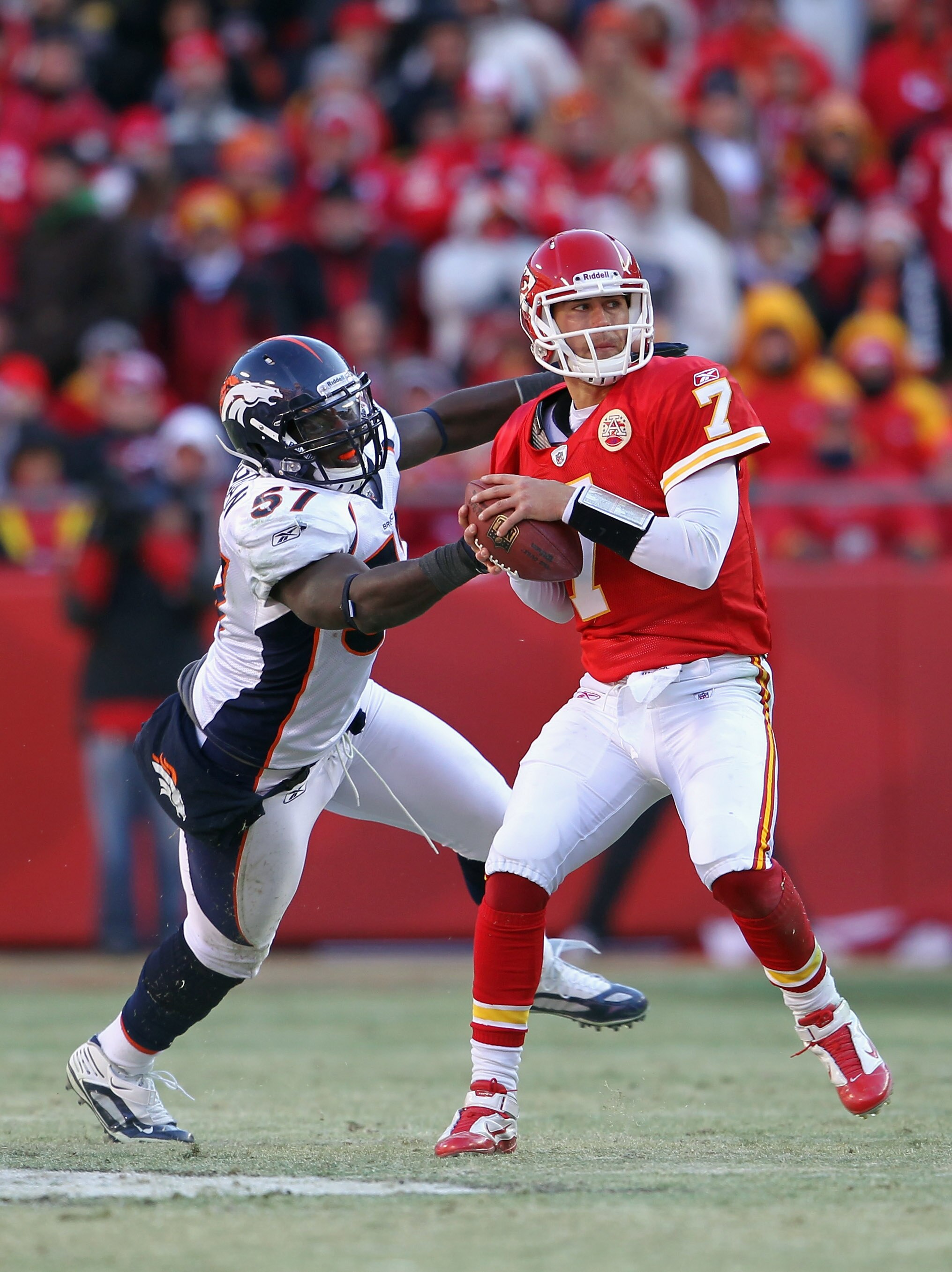 KANSAS CITY, MO - DECEMBER 05:  Quarterback Matt Cassel #7 of the Kansas City Chiefs is pressured by Mario Haggan #57 of the Denver Broncos during the game on December 5, 2010 at Arrowhead Stadium in Kansas City, Missouri.  (Photo by Jamie Squire/Getty Im