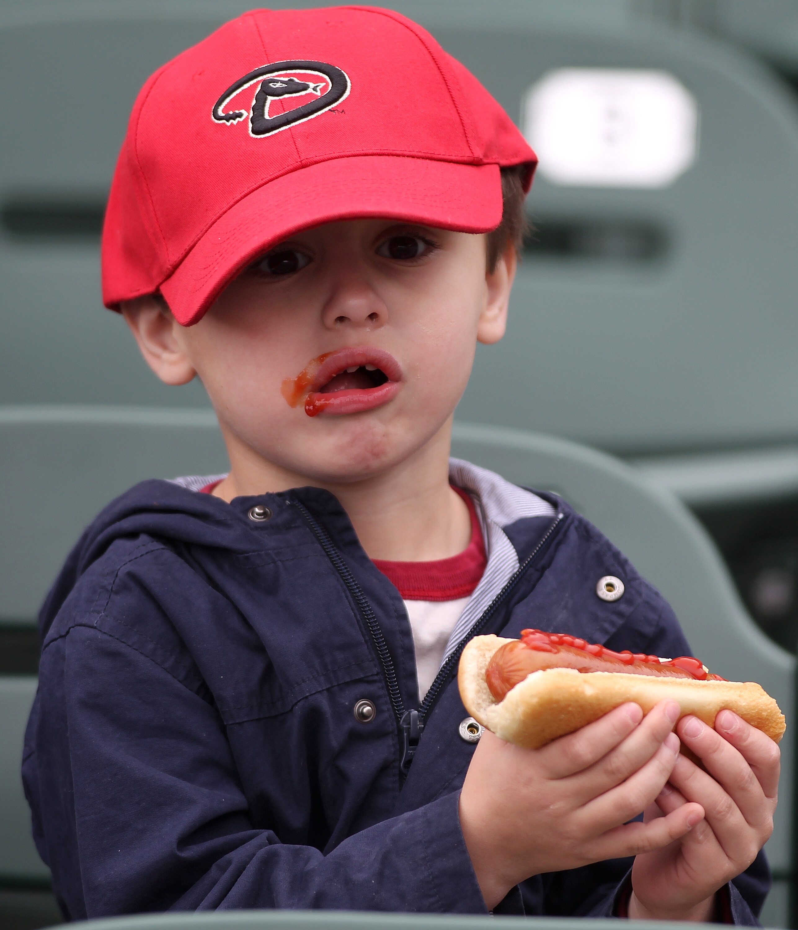 SCOTTSDALE, AZ - FEBRUARY 26:  A young Arizona Diamondbacks fan eats a hot dog before the game between the Colorado Rockies and the Arizona Diamondbacks at Salt River Fields on February 26, 2011in Scottsdale, Arizona..  (Photo by Jonathan Ferrey/Getty Ima