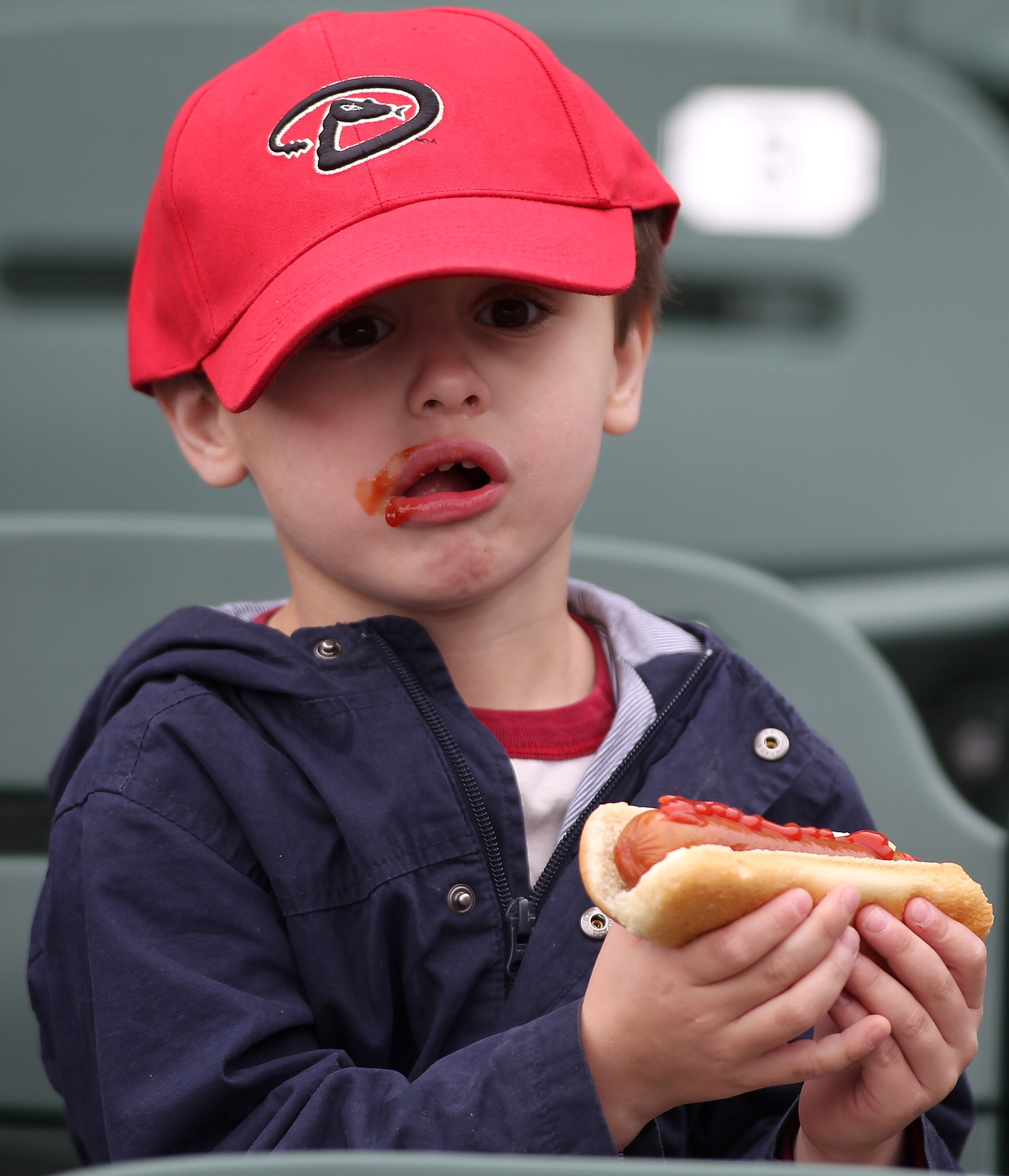 SCOTTSDALE, AZ - FEBRUARY 26:  A young Arizona Diamondbacks fan eats a hot dog before the game between the Colorado Rockies and the Arizona Diamondbacks at Salt River Fields on February 26, 2011in Scottsdale, Arizona..  (Photo by Jonathan Ferrey/Getty Ima