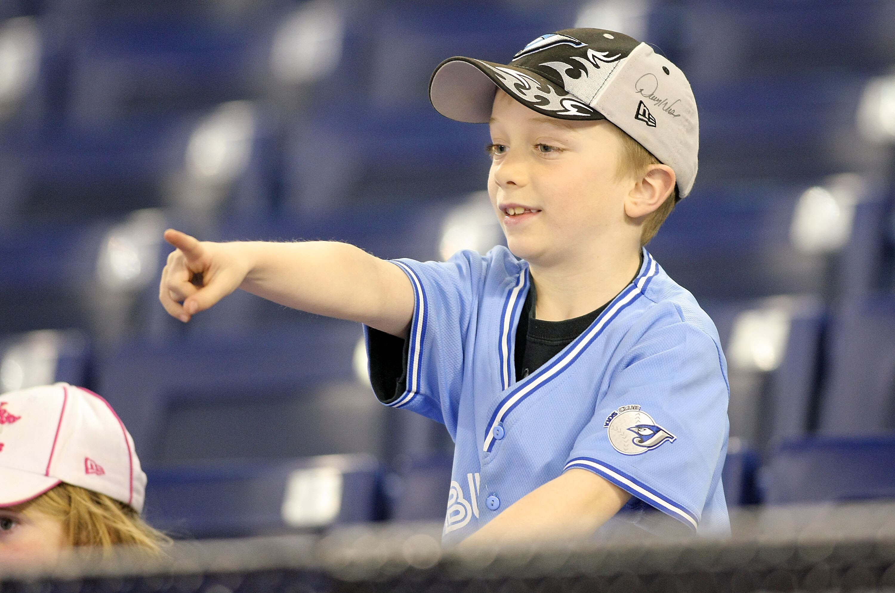 TORONTO,CANADA - APRIL 1:  A young fan points to players on the field prior to the home opener for the Toronto Blue Jays as they face the Minnesota Twins during their MLB game at the Rogers Centre April 1, 2011 in Toronto, Ontario, Canada.(Photo By Dave S