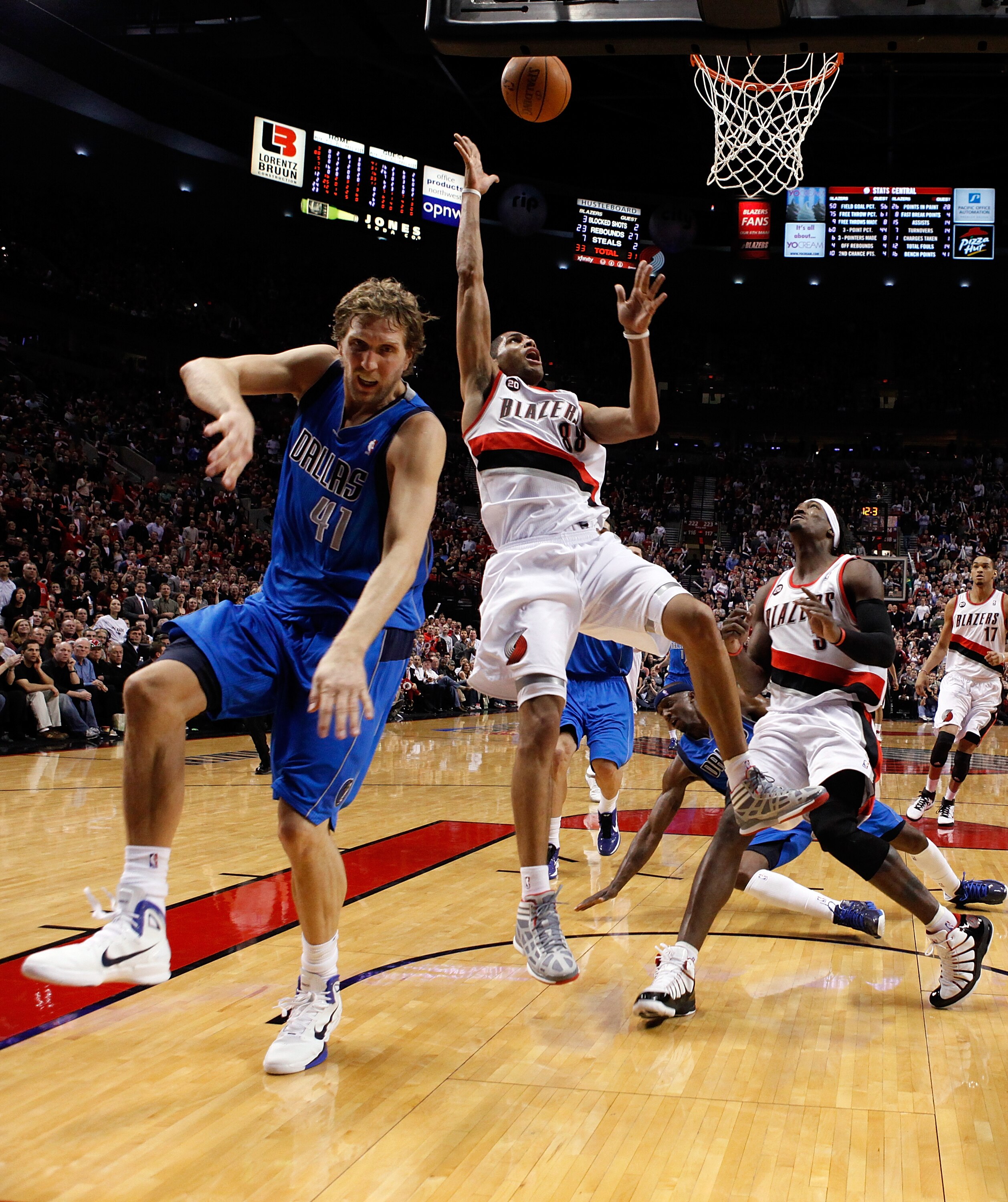 PORTLAND, OR - APRIL 21:  Nicolas Batum #88 of the Portland Trail Blazers shoots the ball against Dirk Nowitzki #41 of the Dallas Mavericks in Game Three of the Western Conference Quarterfinals in the 2011 NBA Playoffs on April 21, 2011 at the Rose Garden