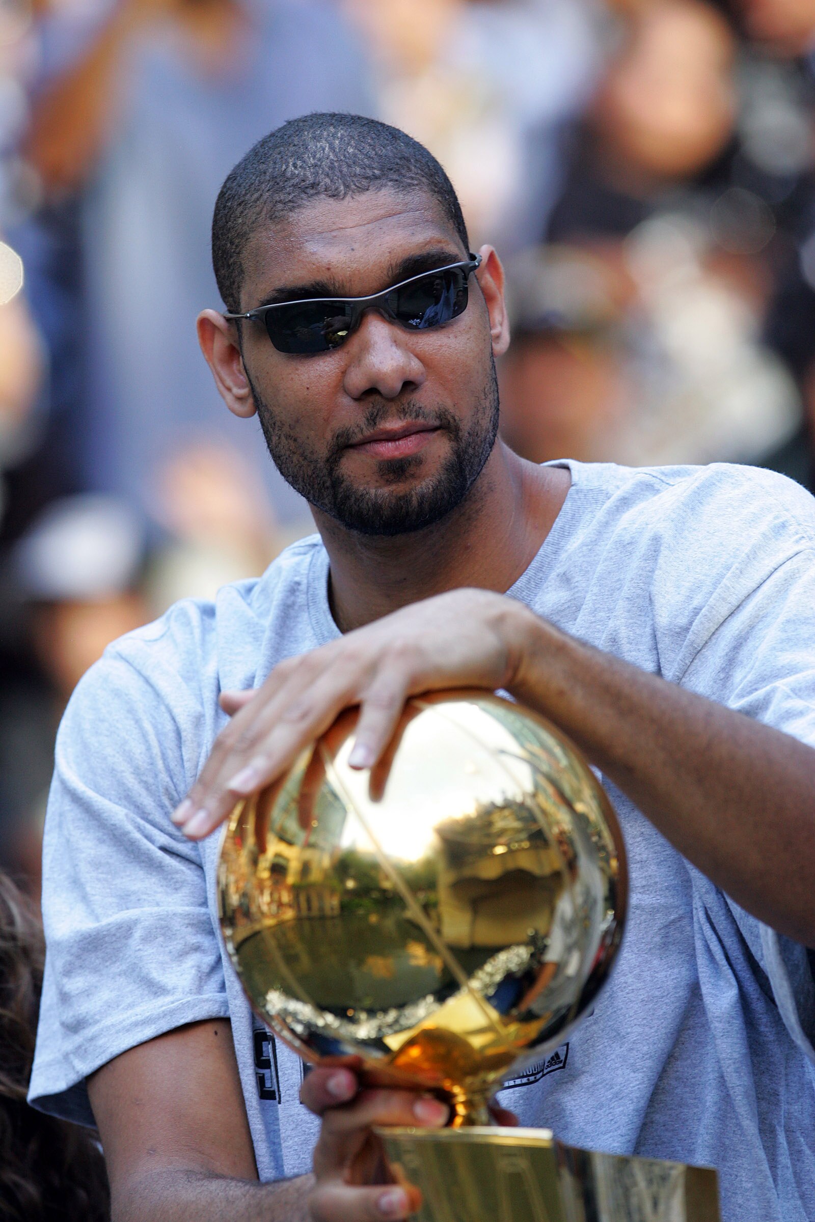 SAN ANTONIO - JUNE 17:  Tim Duncan of the San Antonio Spurs holds the Larry O'Brien trophy during the NBA championship parade down the San Antonio River walk June 17, 2007 in San Antonio, Texas. NOTE TO USER: User expressly acknowledges and agrees that, b