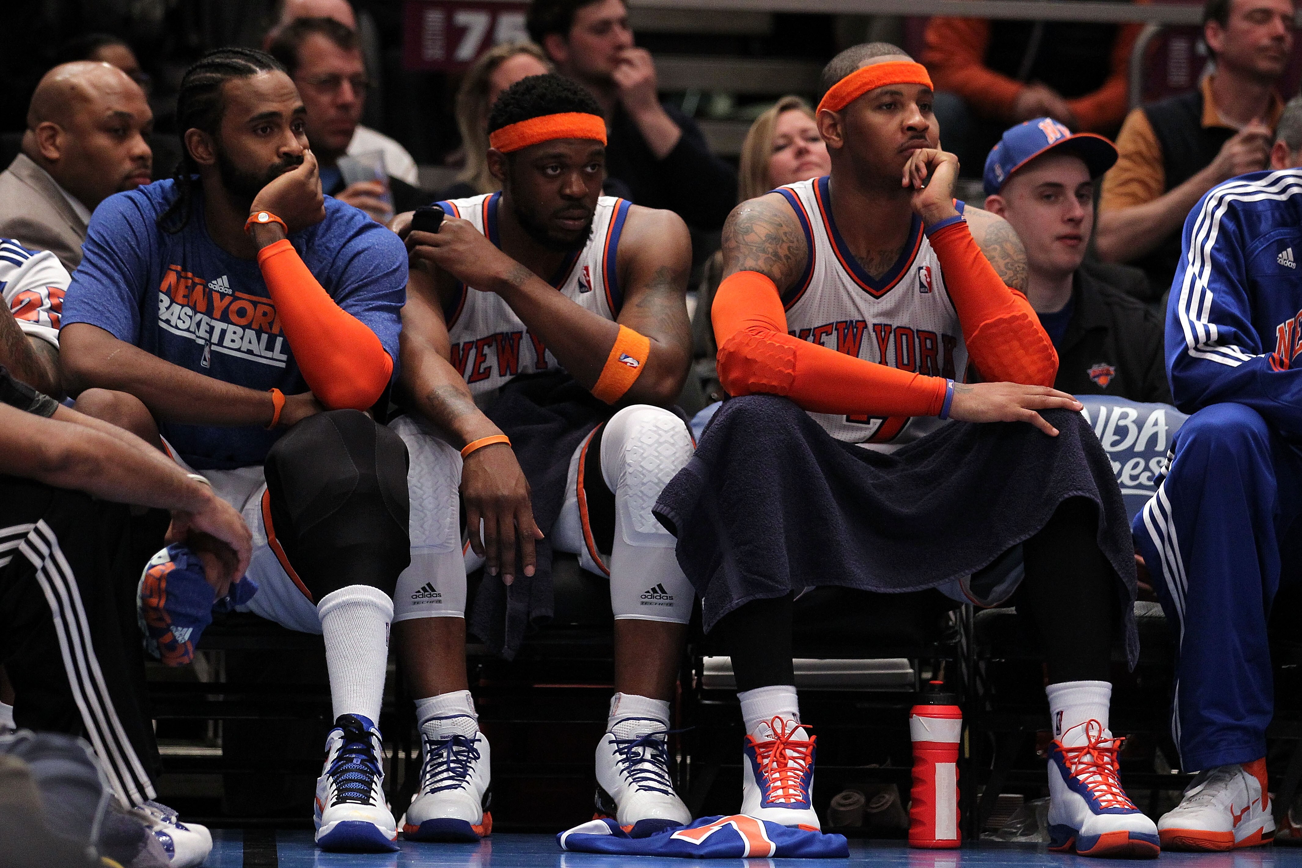 NEW YORK, NY - APRIL 22:  (L-R) Ronny Turiaf #14, Bill Walker #5 and Carmelo Anthony #7 of the New York Knicks look on dejected from the bench against the Boston Celtics in Game Three of the Eastern Conference Quarterfinals in the 2011 NBA Playoffs on Apr