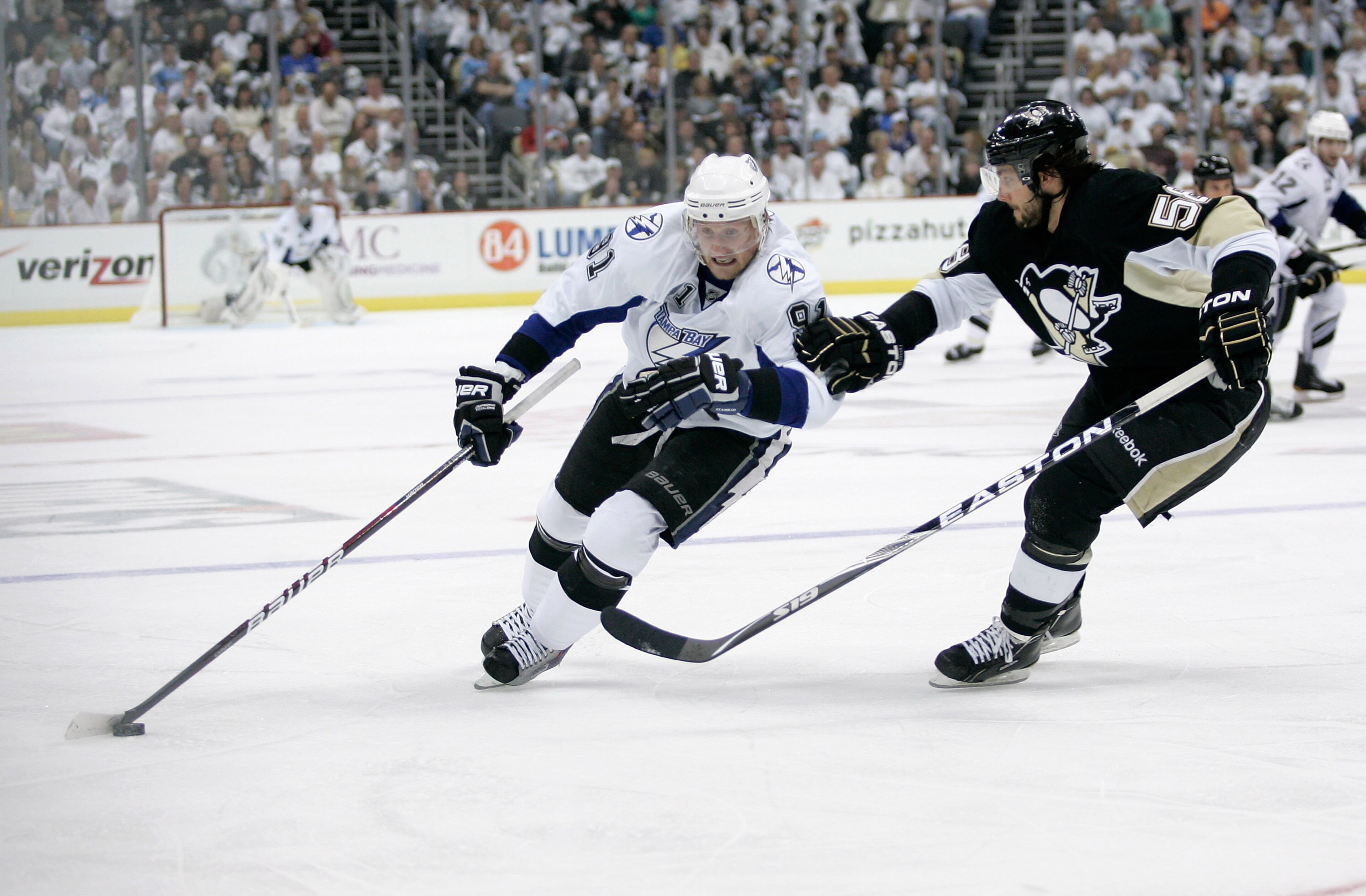 PITTSBURGH, PA - APRIL 15:  Steven Stamkos#91 of the Tampa Bay Lightning controls the puck as Kris Letang #58 of the Pittsburgh Penguins defends during Game Two of the Eastern Conference Quarterfinals during the 2011 NHL Stanley Cup Playoffs at Consol Ene