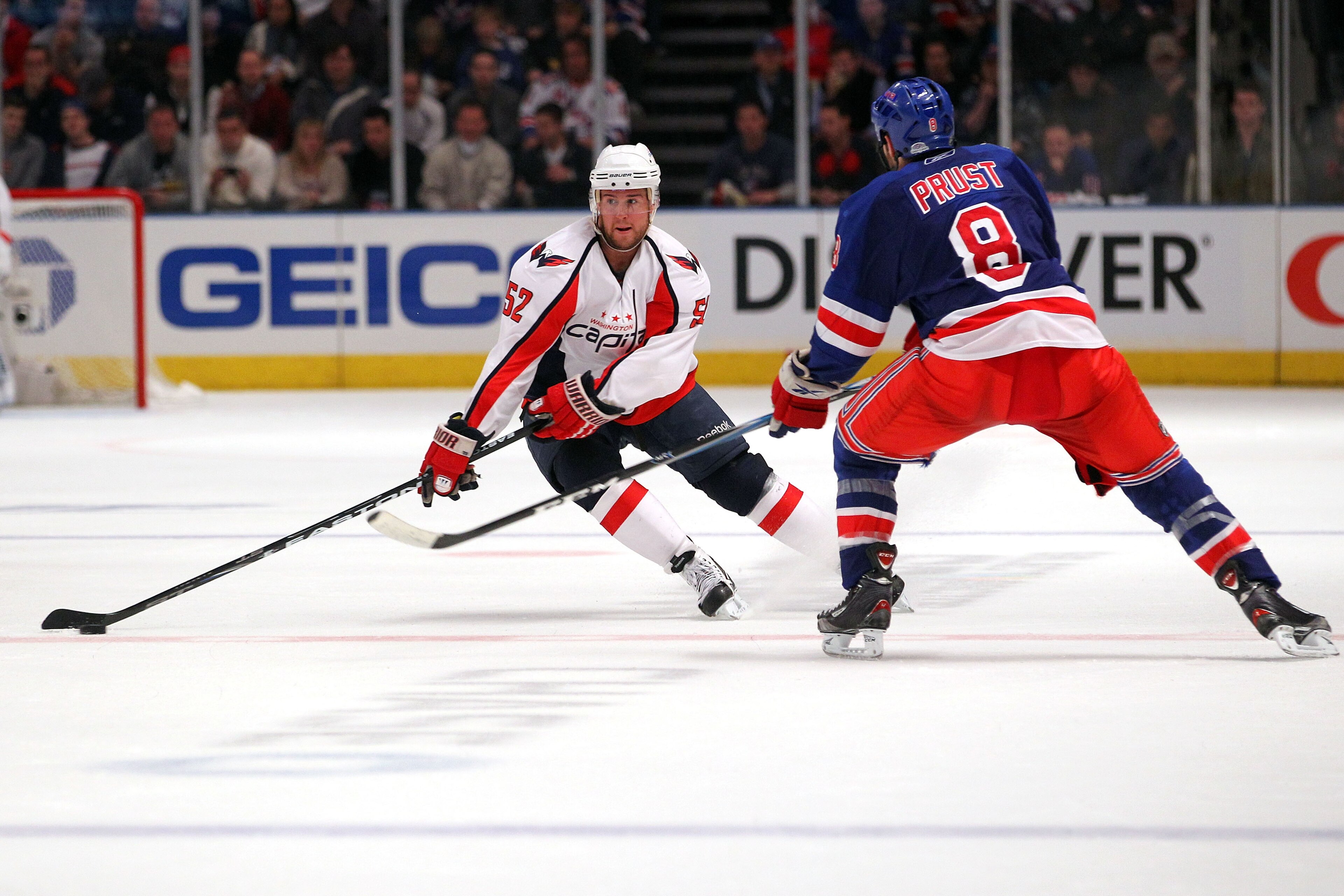 NEW YORK, NY - APRIL 17:  Mike Green #52 of the Washington Capitals skates against Brandon Prust #8 of the New York Rangers in Game Three of the Eastern Conference Quarterfinals during the 2011 NHL Stanley Cup Playoffs at Madison Square Garden on April 17