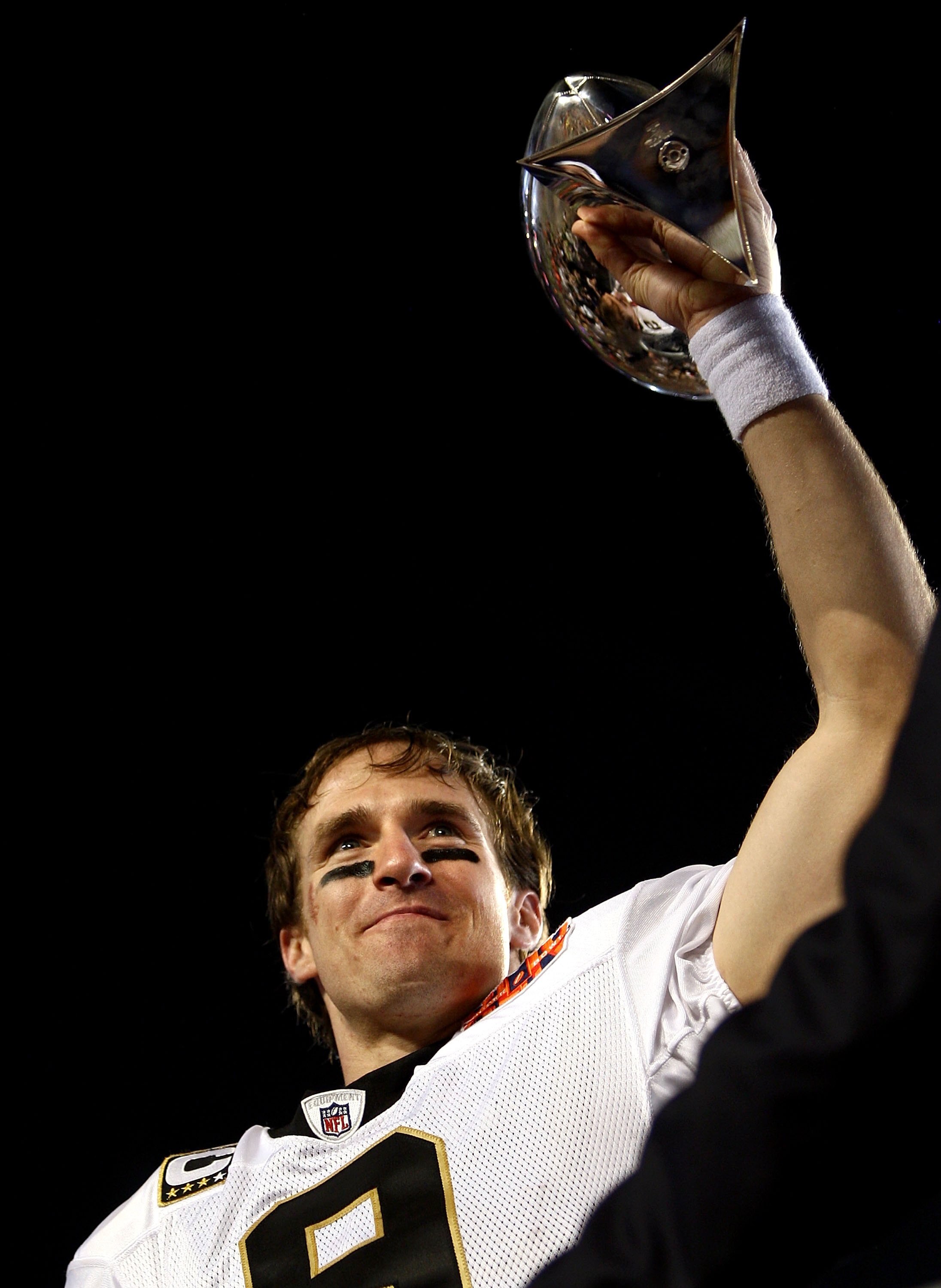 MIAMI GARDENS, FL - FEBRUARY 07:  Quarterback Drew Brees #9 of the New Orleans Saints lifts the Vince Lombardi trophy after his team defeated the Indianapolis Colts during Super Bowl XLIV on February 7, 2010 at Sun Life Stadium in Miami Gardens, Florida.