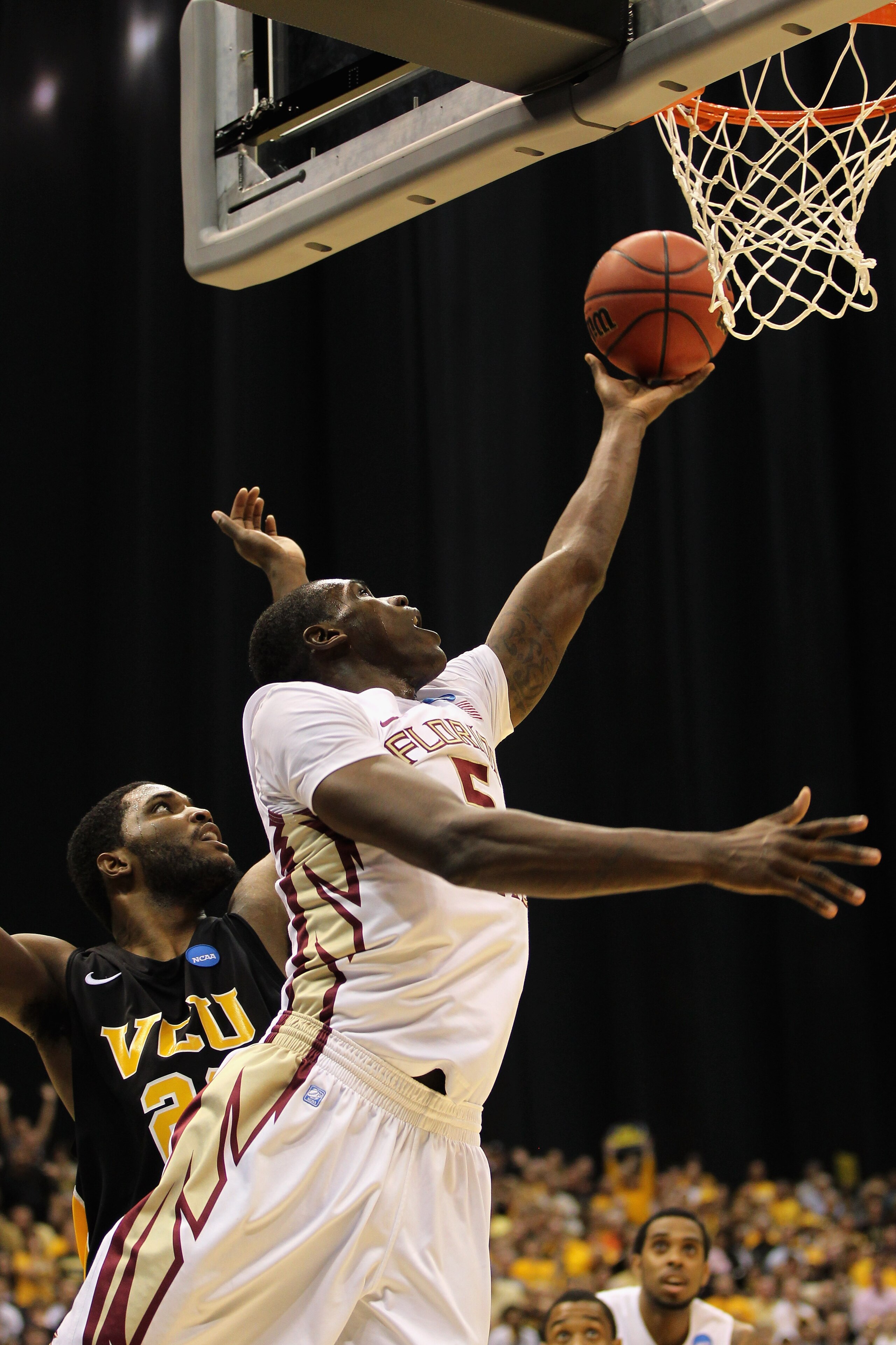 SAN ANTONIO, TX - MARCH 25:  Bernard James #5 of the Florida State Seminoles goes to the basket against Jamie Skeen #21 of the Virginia Commonwealth Rams during the southwest regional of the 2011 NCAA men's basketball tournament at the Alamodome on March