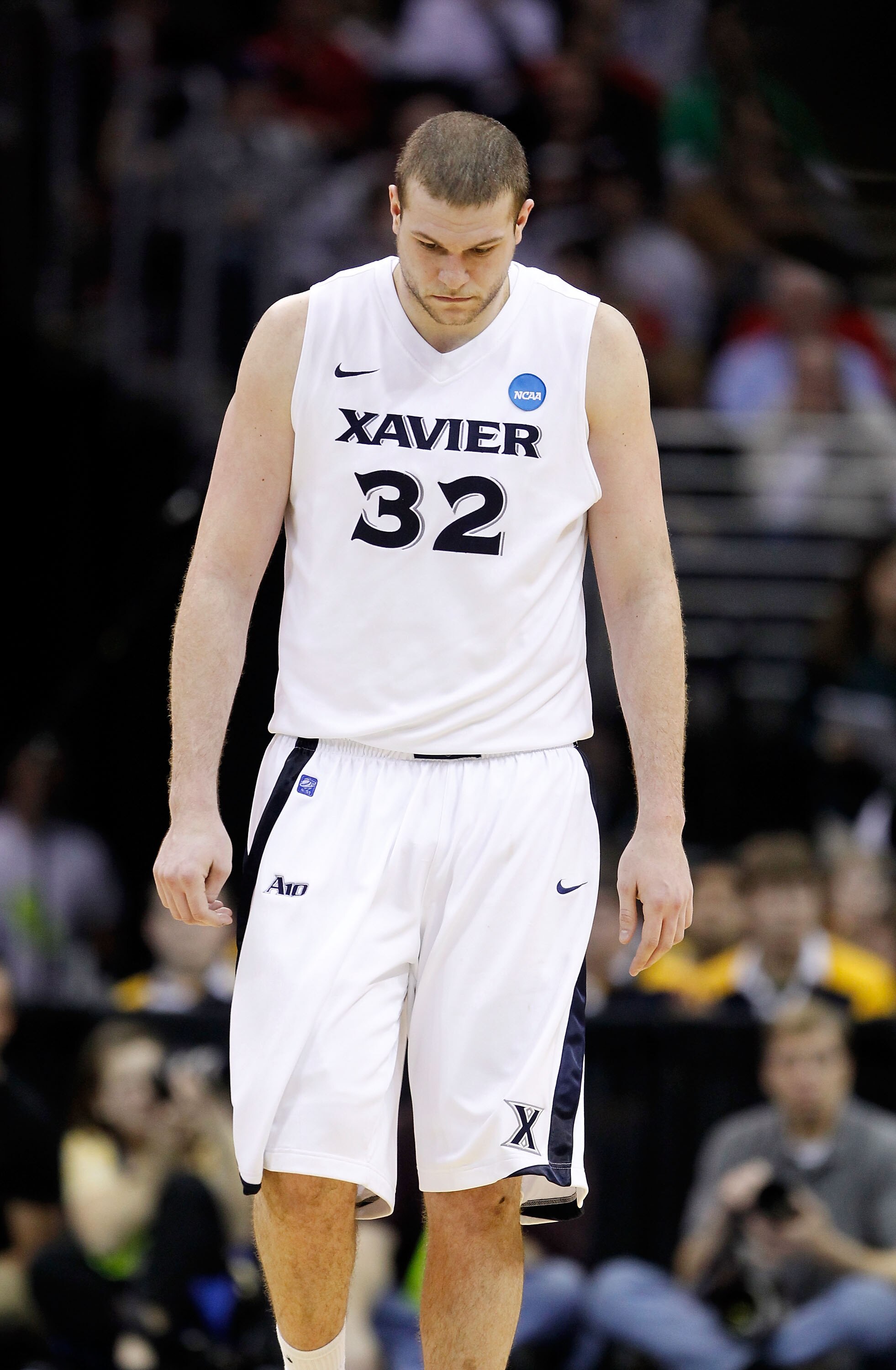 CLEVELAND, OH - MARCH 18: Kenny Frease #32 of the Xavier Musketeers walks with his head down late in the second half against the Marquette Golden Eagles during the second round of the 2011 NCAA men's basketball tournament at Quicken Loans Arena on March 1