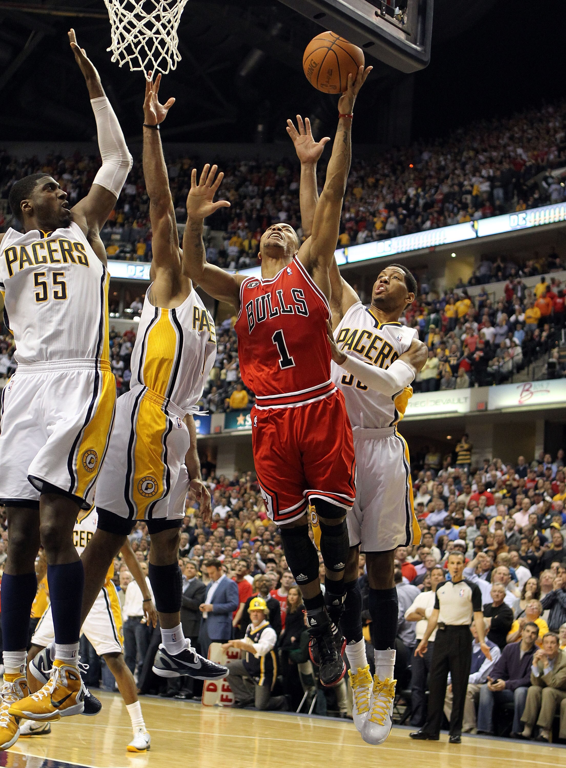 INDIANAPOLIS, IN - APRIL 21:  Derrick Rose #1 of the Chicago Bulls launches the game winning shot while defended by Roy Hibbert #55, Dahntay Jones #1 and Danny Granger #33 of the Indiana Pacers in Game three of the Eastern Conference Quarterfinals in the