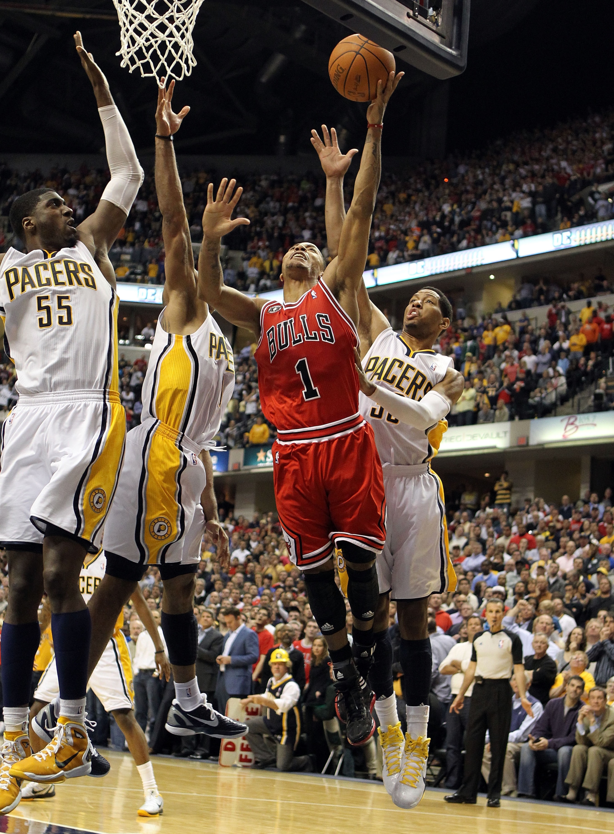 INDIANAPOLIS, IN - APRIL 21:  Derrick Rose #1 of the Chicago Bulls launches the game winning shot while defended by Roy Hibbert #55, Dahntay Jones #1 and Danny Granger #33 of the Indiana Pacers in Game three of the Eastern Conference Quarterfinals in the