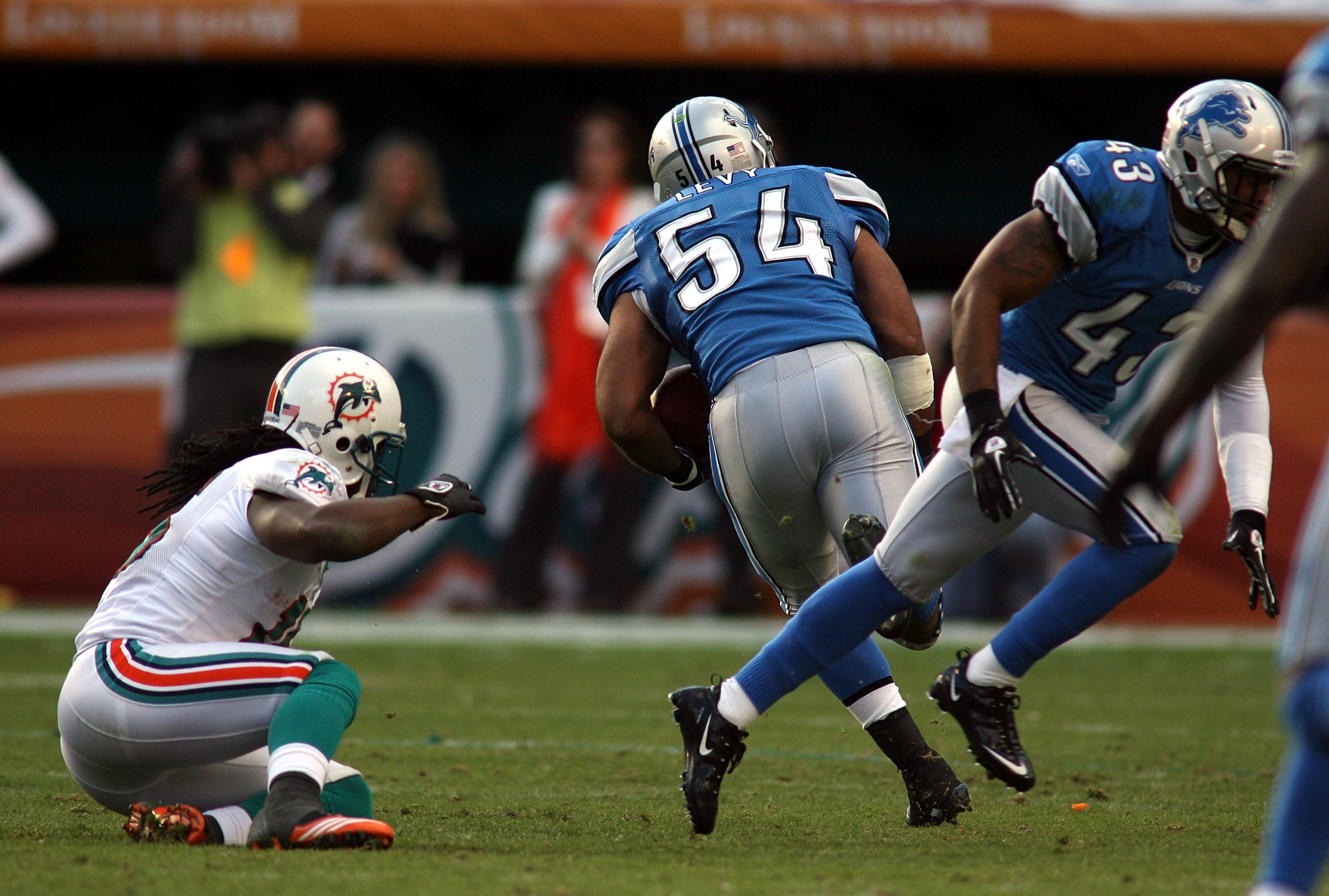 MIAMI - DECEMBER 26:  Linebacker DeAndre Levy #54 of the Detroit Lions runs in the game winning interception against the Miami Dolphins at Sun Life Stadium on December 26, 2010 in Miami, Florida. The Lions defeated the Dolphins 34-27.  (Photo by Marc Sero