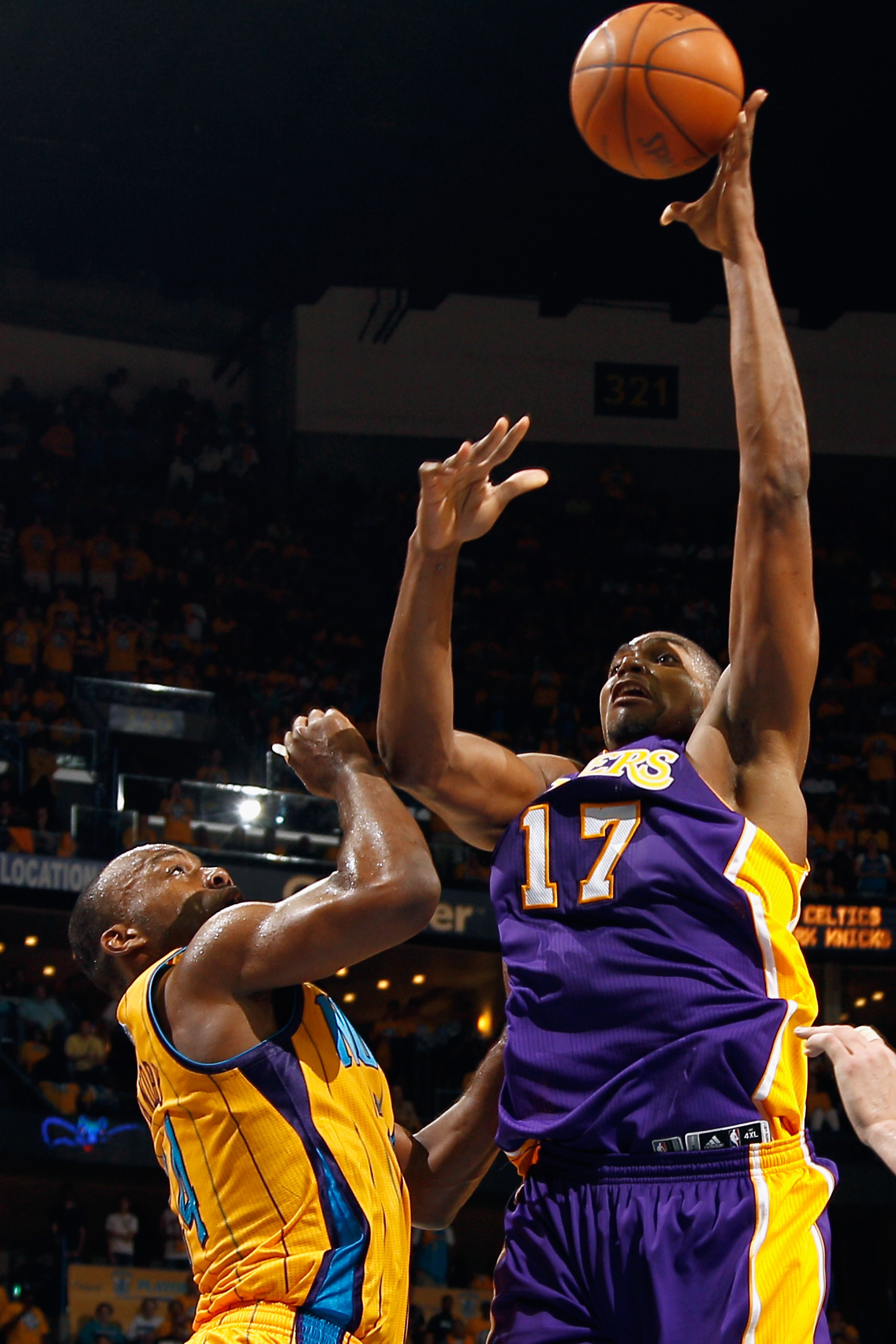 NEW ORLEANS, LA - APRIL 22:  Andrew Bynum #17 of the Los Angeles Lakers shoots the ball over Marco Belinelli #8 of the New Orleans Hornets in Game Three of the Western Conference Quarterfinals in the 2011 NBA Playoffs at the New Orleans Arena  on April 22