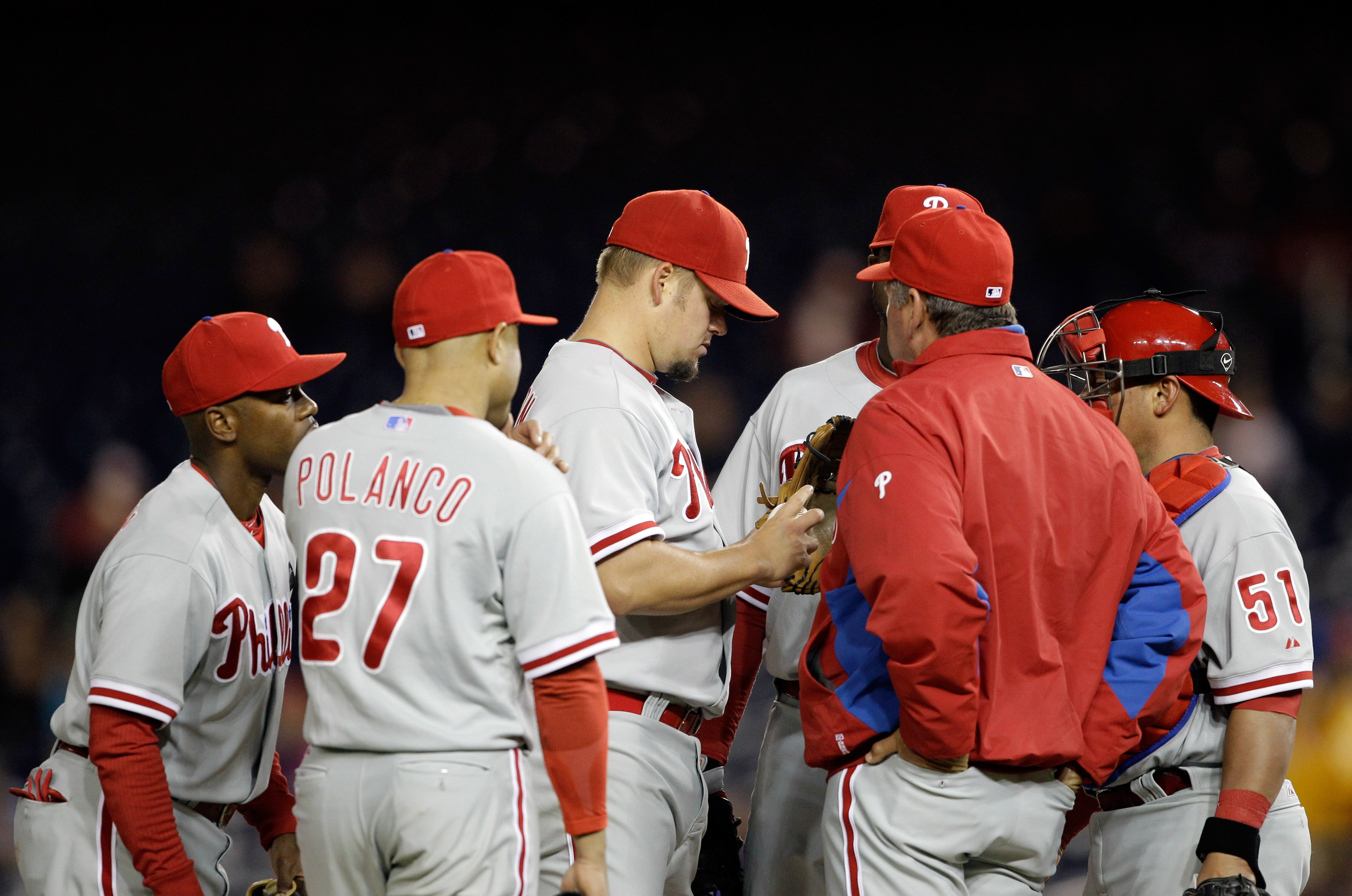 WASHINGTON, DC - APRIL 12: Starting pitcher Joe Blanton #56 of the Philadelphia Phillies (C) talks with pitching coach Rich Dubee (R) during the fourth inning against the Washington Nationals at Nationals Park on April 12, 2011 in Washington, DC. (Photo b