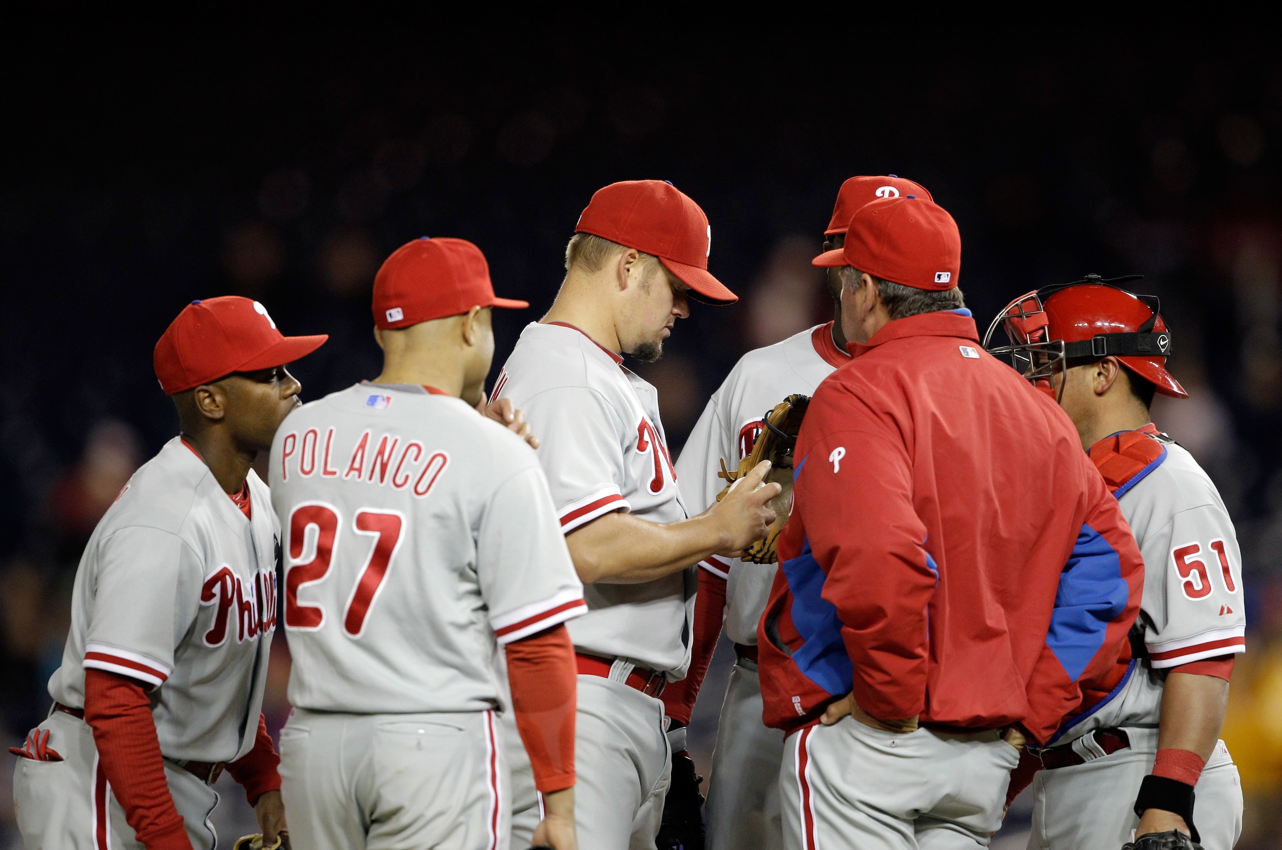 WASHINGTON, DC - APRIL 12: Starting pitcher Joe Blanton #56 of the Philadelphia Phillies (C) talks with pitching coach Rich Dubee (R) during the fourth inning against the Washington Nationals at Nationals Park on April 12, 2011 in Washington, DC. (Photo b