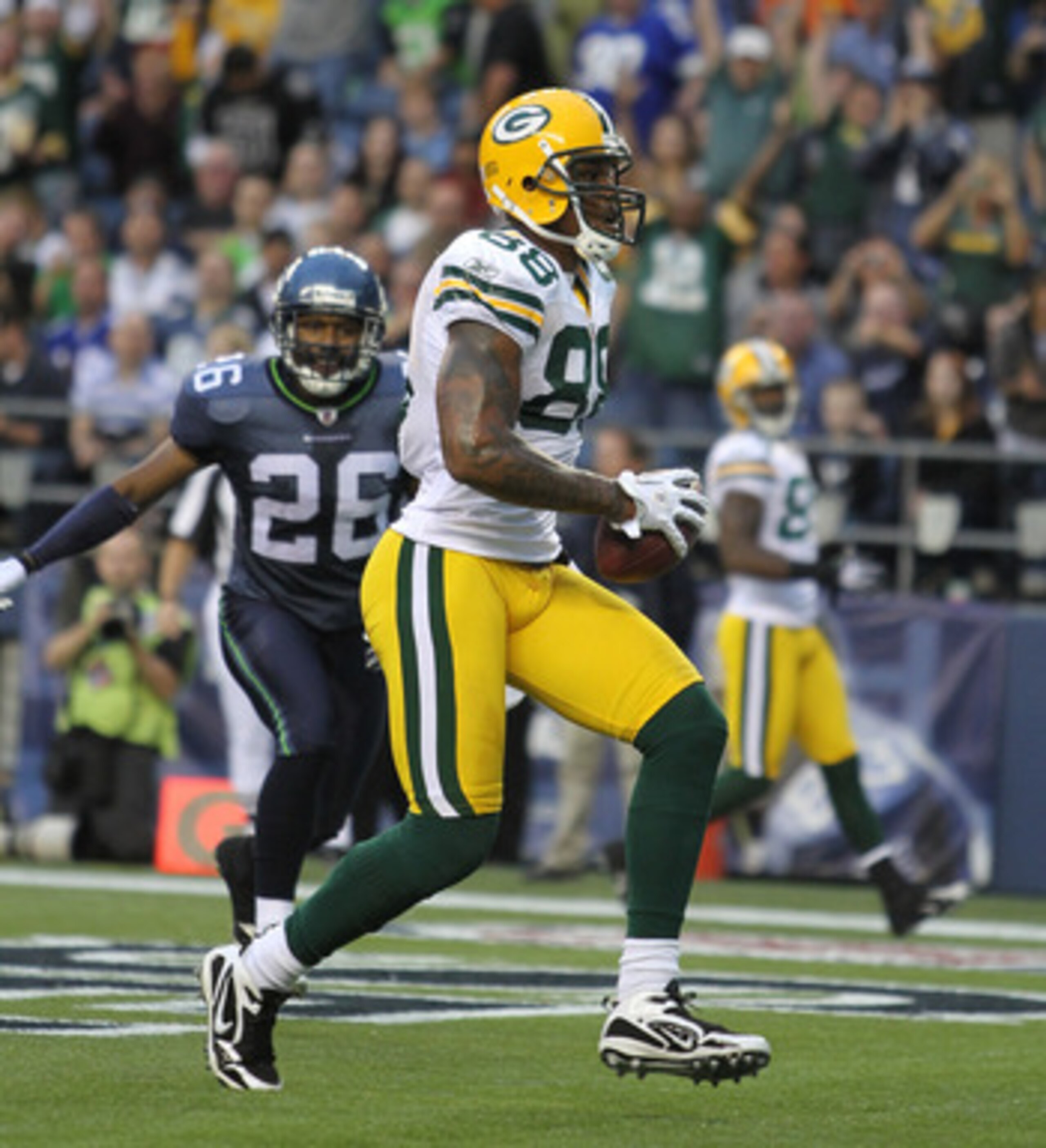 SEATTLE - AUGUST 21:  Tight end Jermichael Finley #88 of the Green Bay Packers scores a touchdown during the preseason game against Josh Wilson #26 of the Seattle Seahawks at Qwest Field on August 21, 2010 in Seattle, Washington. (Photo by Otto Greule Jr/