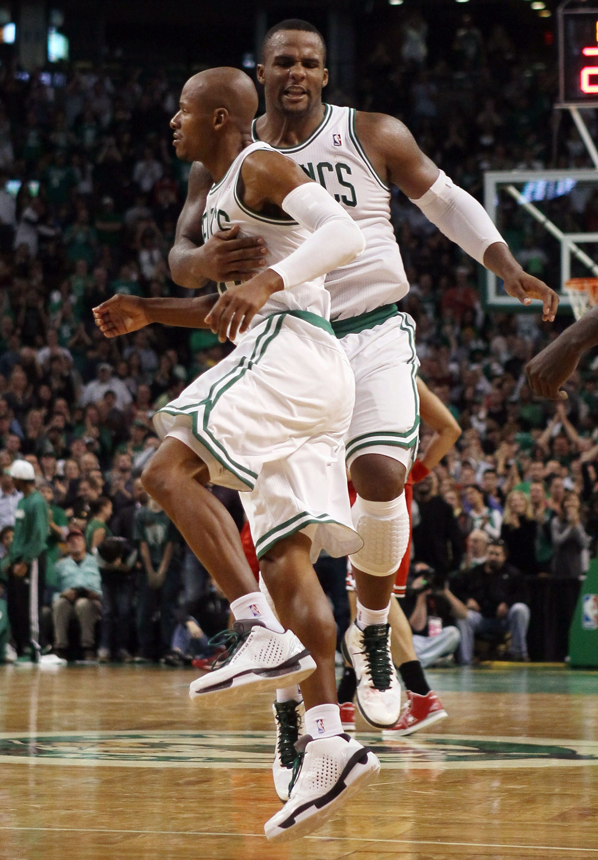BOSTON - NOVEMBER 05:  Ray Allen #20 of the Boston Celtics is congratulated by teammate Glen Davis #11 after Allen dunked the ball in overtime against the Chicago Bulls on November 5, 2010 at the TD Garden in Boston, Massachusetts. The Celtics defeated th