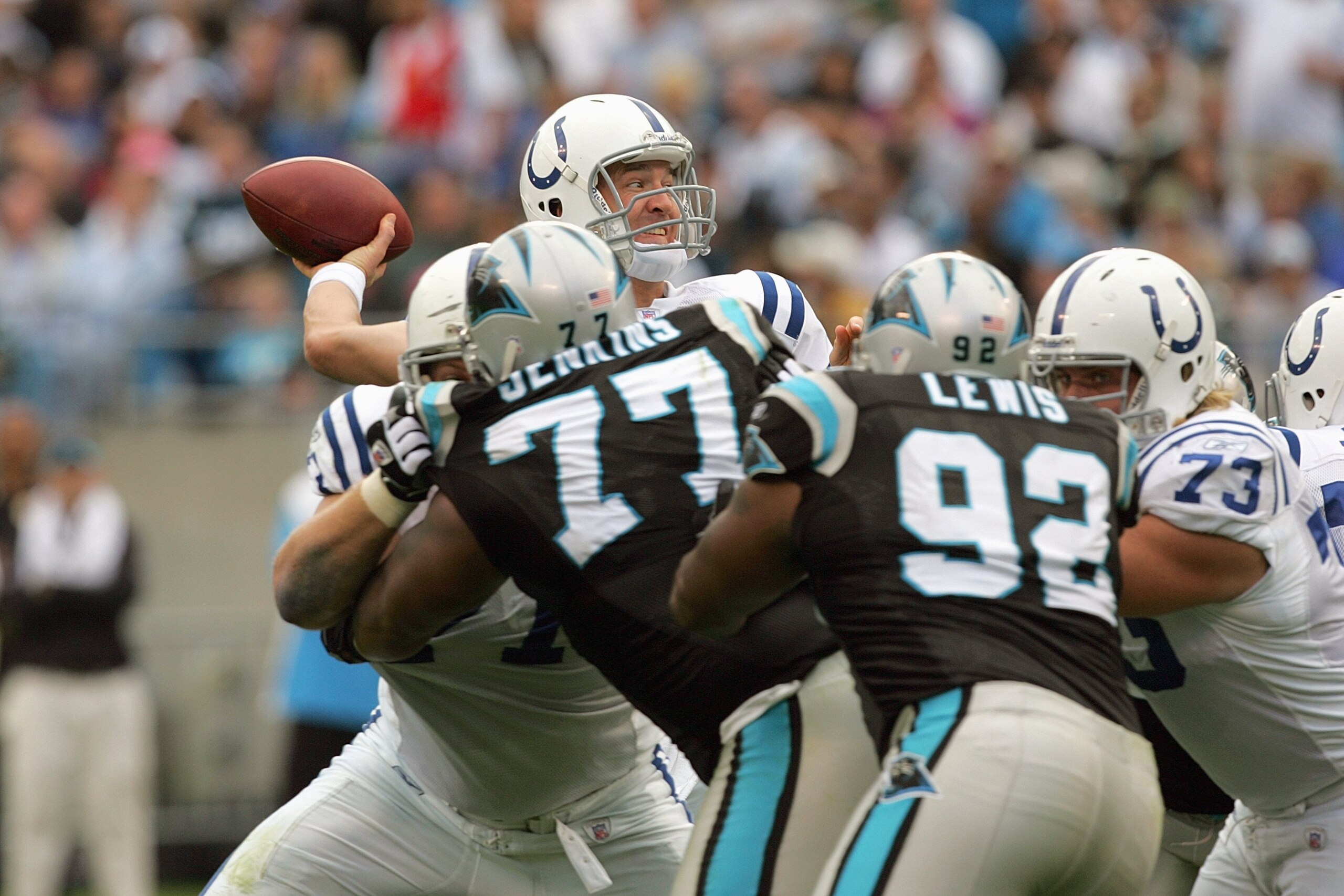 CHARLOTTE, NC - OCTOBER 28: Peyton Manning #18 of the Indianapolis Colts tries to pass as the is sacked by Kris Jenkins #77 of the Carolina Panthers during their game at Bank of America Stadium on October 28, 2007 in Charlotte, North Carolina. (Photo by S