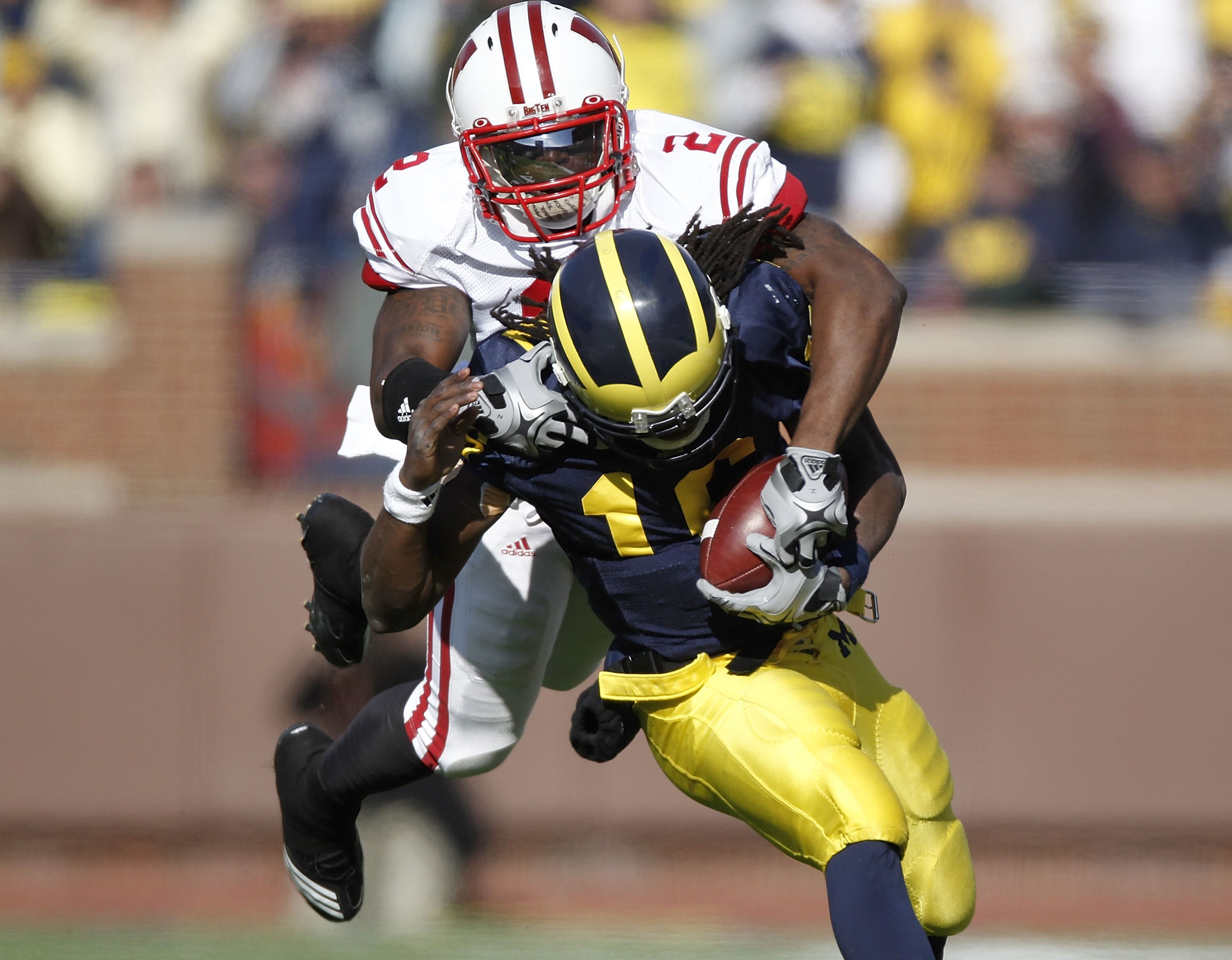 ANN ARBOR, MI - NOVEMBER 20: Jay Valai #2 of the Wisconsin Badgers tackles Denard Robinson #16 of the Michigan Wolverines at Michigan Stadium on November 20, 2010 in Ann Arbor, Michigan.  (Photo by Gregory Shamus/Getty Images)