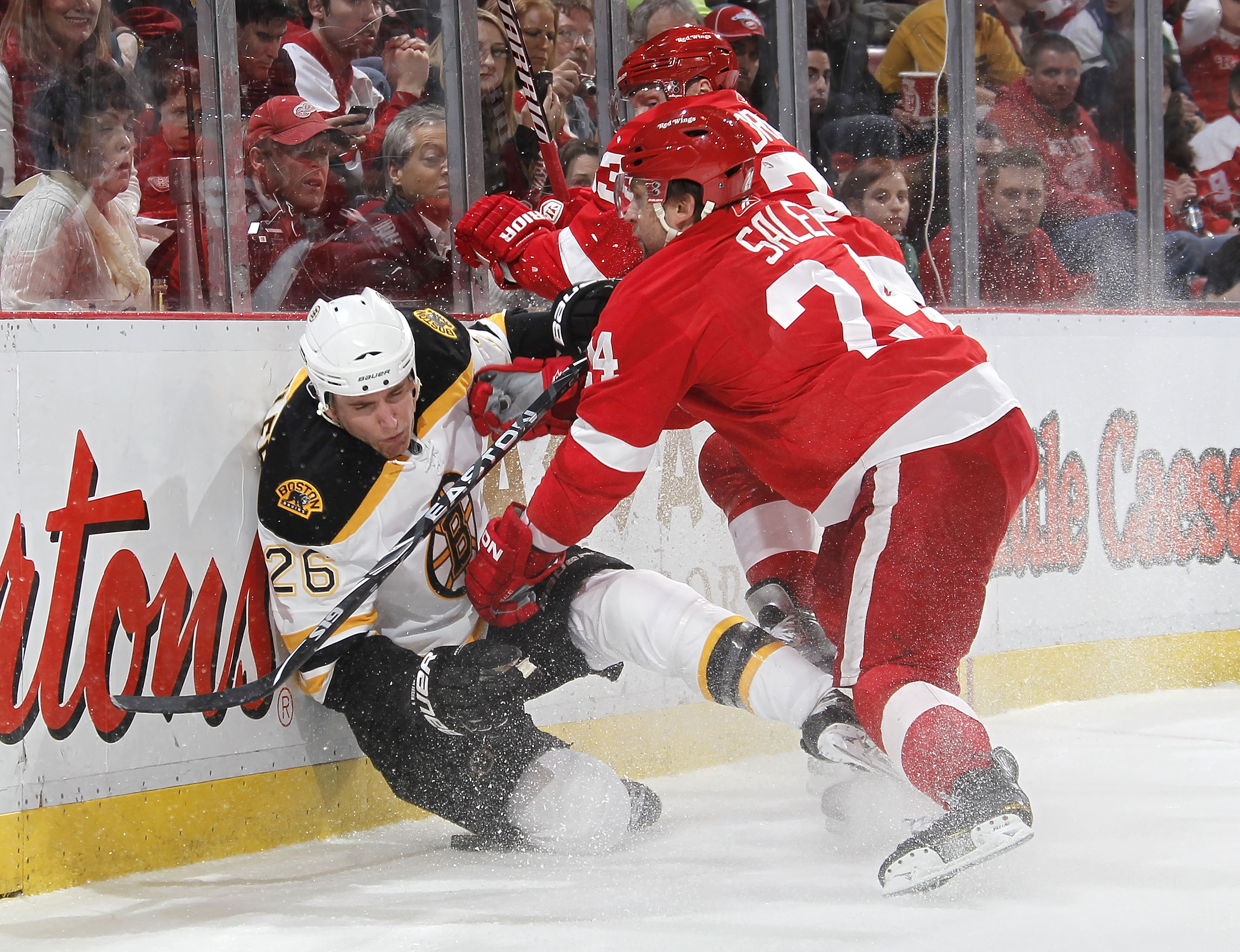 DETROIT, MI - FEBRUARY 13:  Ruslan Salei #24 of the Detroit Red Wings checks Blake Wheeler #26 of the Boston Bruins into the boards on February 13, 2011 at Joe Lewis Arena in Detroit, Michigan. Detroit won the game 4-2.  (Photo by Gregory Shamus/Getty Ima