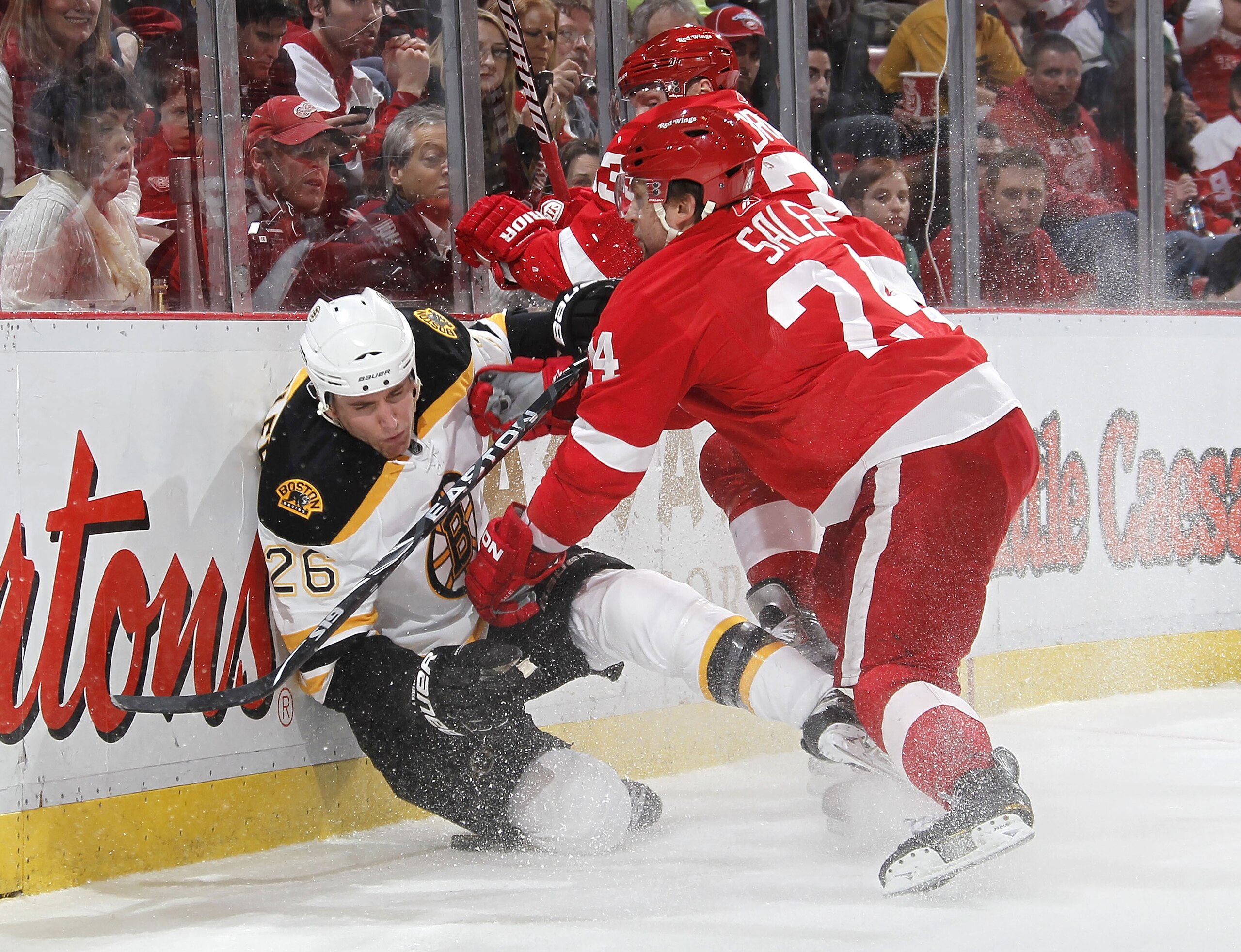 DETROIT, MI - FEBRUARY 13:  Ruslan Salei #24 of the Detroit Red Wings checks Blake Wheeler #26 of the Boston Bruins into the boards on February 13, 2011 at Joe Lewis Arena in Detroit, Michigan. Detroit won the game 4-2.  (Photo by Gregory Shamus/Getty Ima