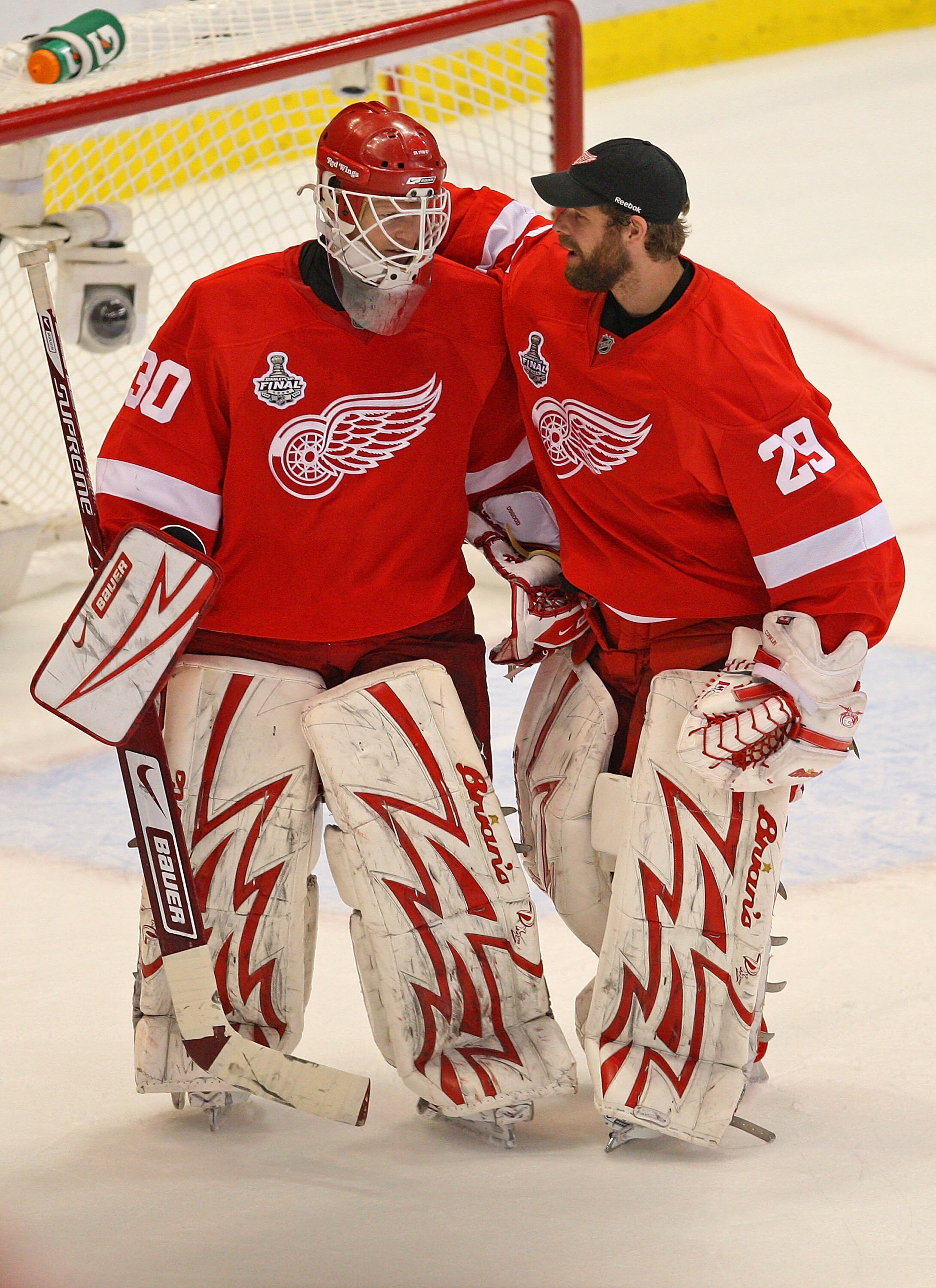 DETROIT - JUNE 06:  Goaltender Chris Osgood #30 of the Detroit Red Wings is congratulated by backup goaltender Ty Conklin #29 after a 5-0 win over the Pittsburgh Penguins in Game Five of the 2009 NHL Stanley Cup Finals at Joe Louis Arena on June 6, 2009 i