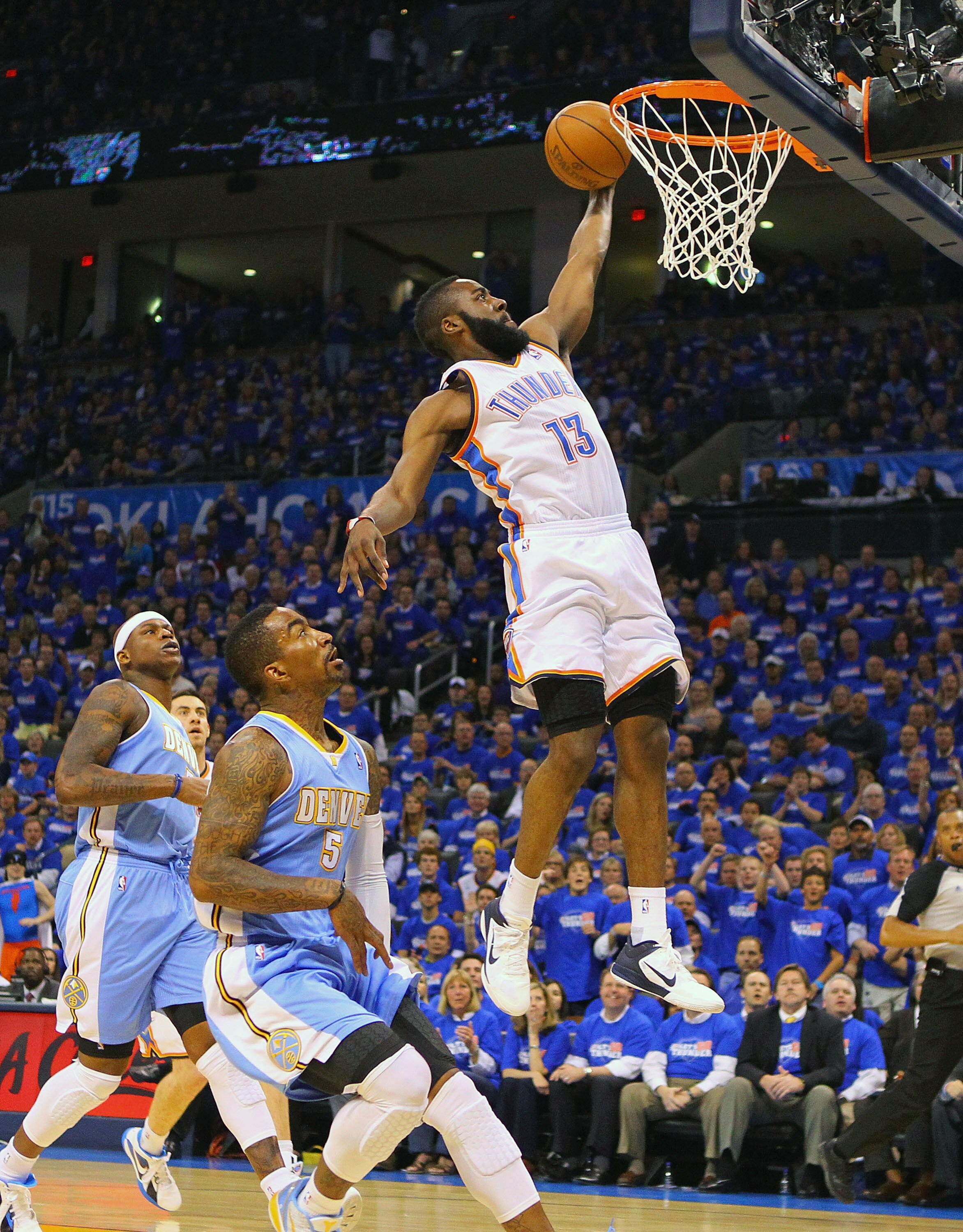 OKLAHOMA CITY, OK - APRIL 20: James Harden #13 of the Oklahoma City Thunder dunks the ball against J.R. Smith #5 of the Denver Nuggets in Game Two of the Western Conference Quarterfinals in the 2011 NBA Playoffs on April 20, 2011 at the Ford Center in Okl