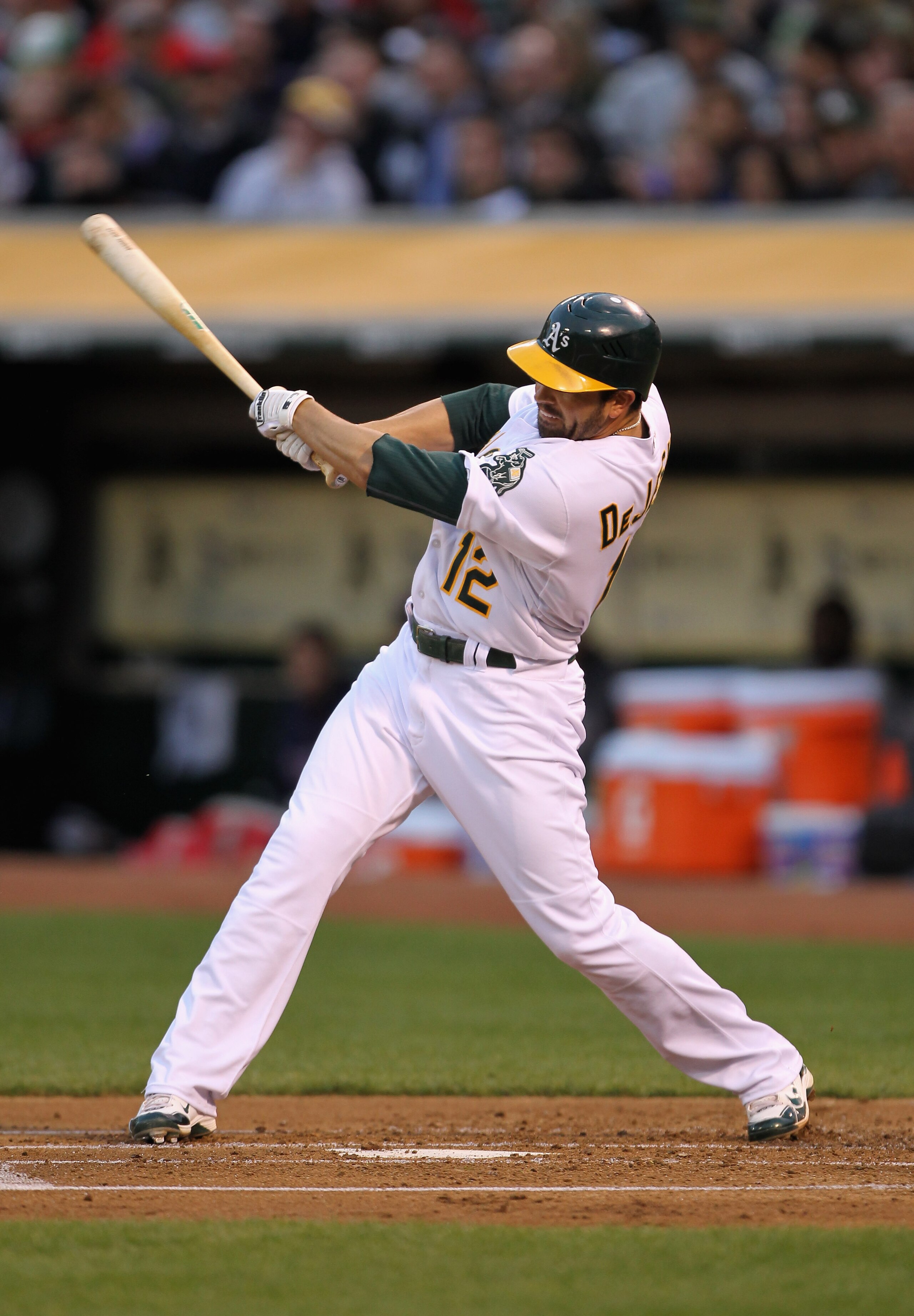 OAKLAND, CA - APRIL 19:  David DeJesus #12 of the Oakland Athletics hits an RBI ground out that scored Coco Crisp #4 to give the Oakland Athletics a 1-0 over the Boston Red Sox at Oakland-Alameda County Coliseum on April 19, 2011 in Oakland, California.