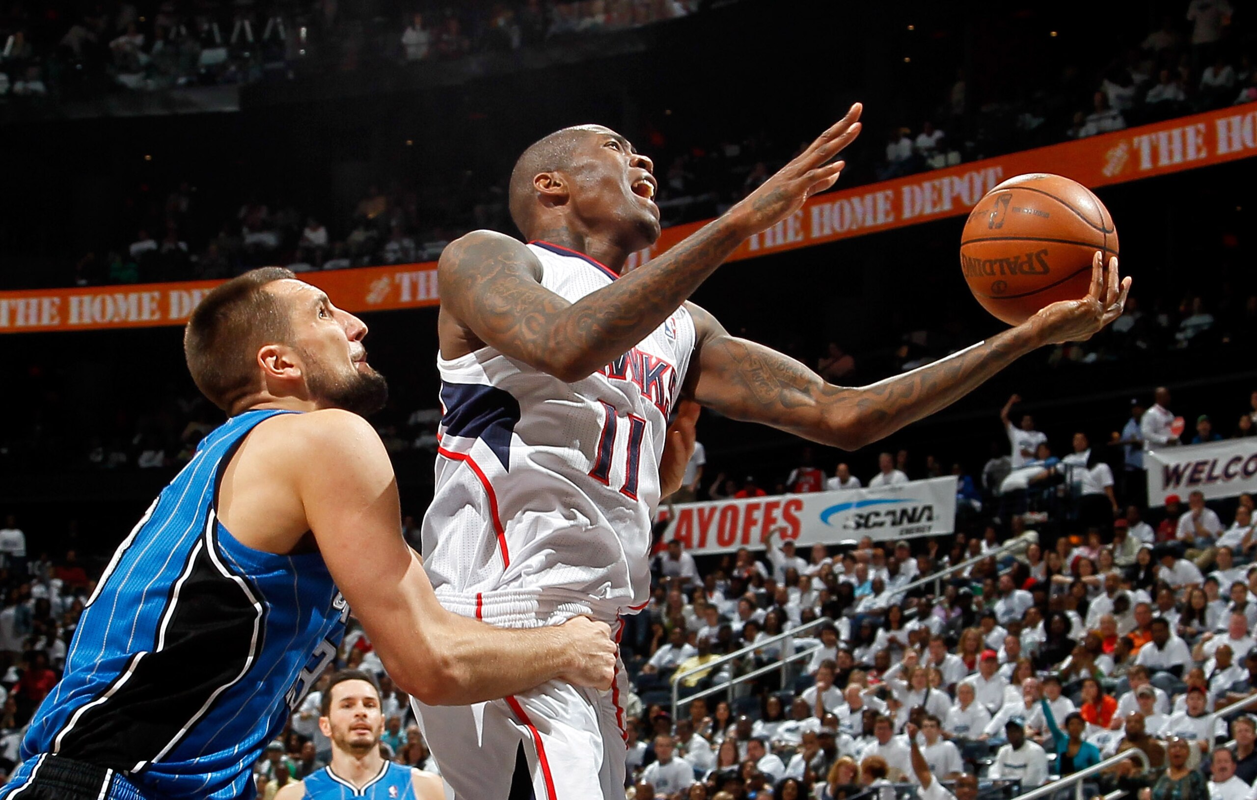 ATLANTA, GA - APRIL 22:  Jamal Crawford #11 of the Atlanta Hawks draws a foul from Ryan Anderson #33 of the Orlando Magic during Game Three of the Eastern Conference Quarterfinals in the 2011 NBA Playoffs at Philips Arena on April 22, 2011 in Atlanta, Geo