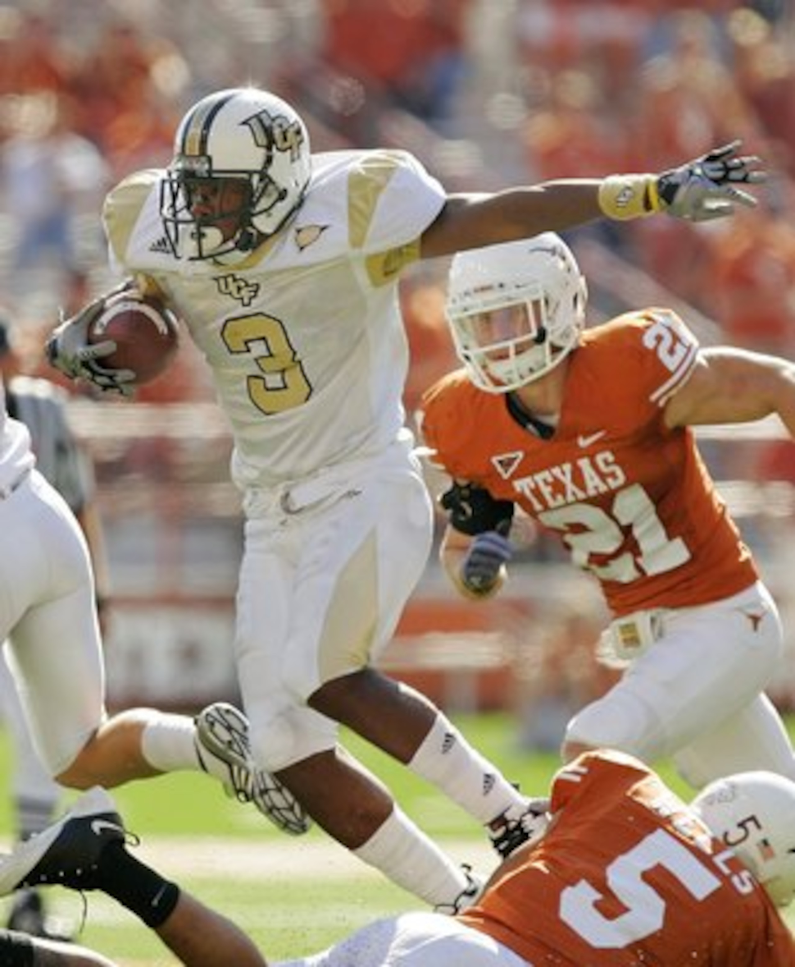 AUSTIN, TX - NOVEMBER 07:  Safety Ben Wells #5 of the Texas Longhorns tackles wide receiver A.J. Guyton #3 of the UCF Knights on November 7, 2009 at Darrell K Royal - Texas Memorial Stadium in Austin, Texas.  Texas won 35-3.  (Photo by Brian Bahr/Getty Im