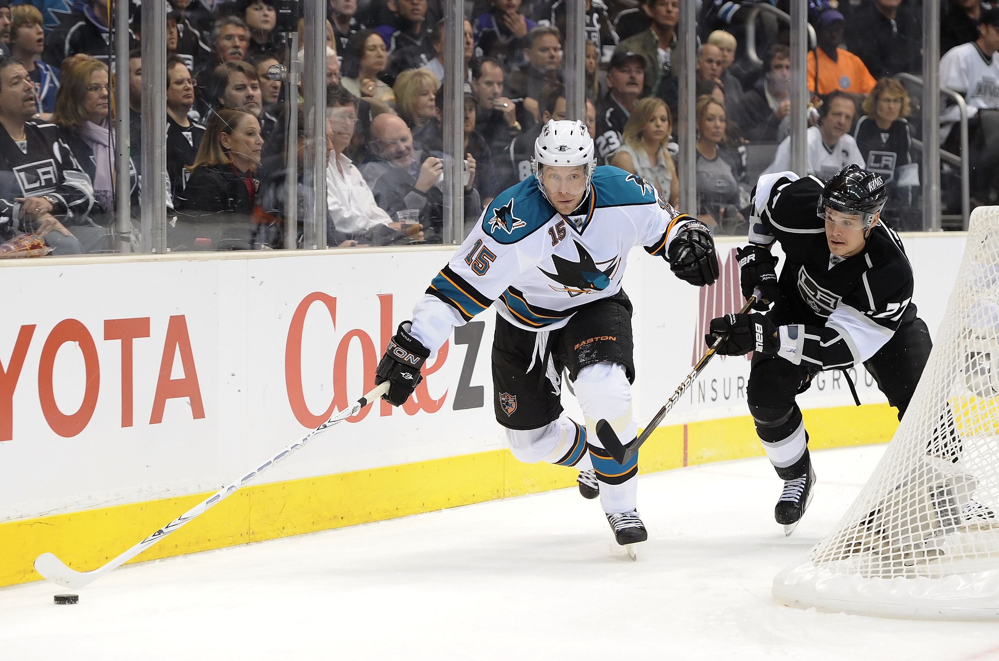 LOS ANGELES, CA - APRIL 21:  Dany Heatley #15 of the San Jose Sharks skates with the puck as Alexei Ponikarovsky #27 of the Los Angeles Kings chases after him in game four of the Western Conference Quarterfinals during the 2011 NHL Stanley Cup Playoffs at