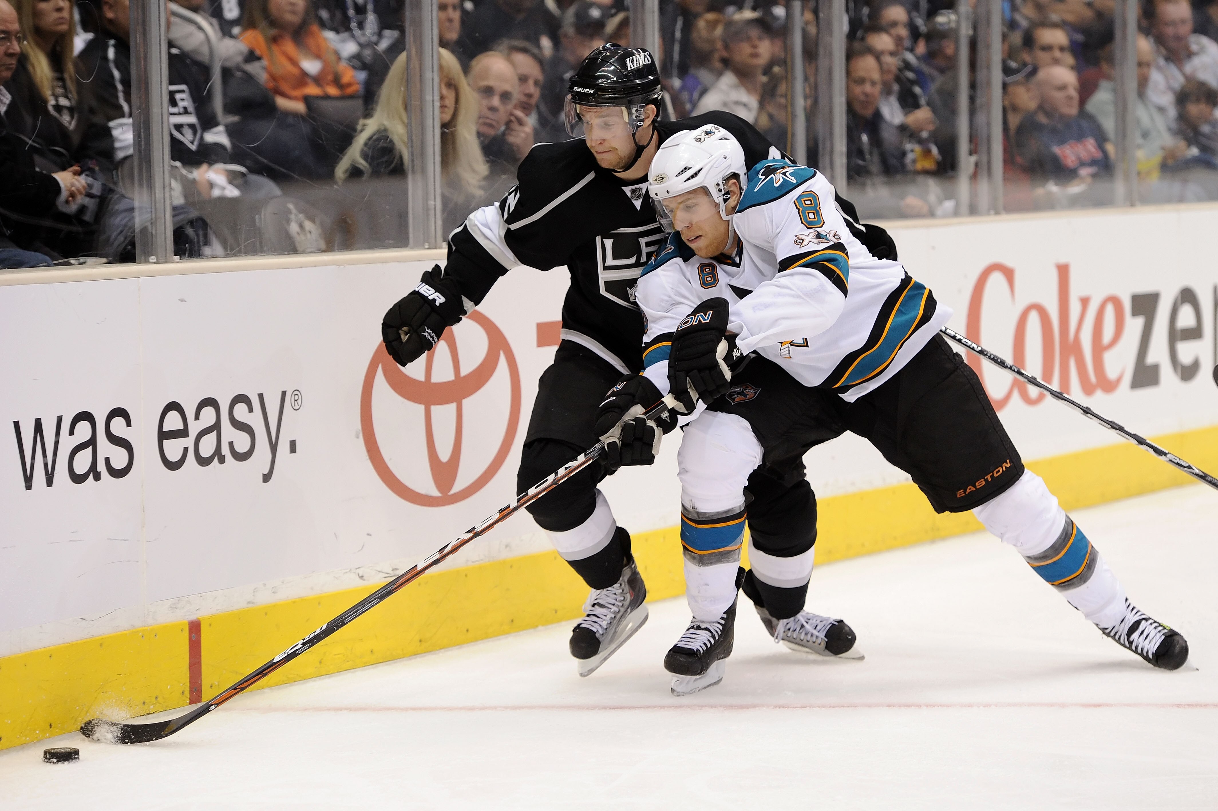 LOS ANGELES, CA - APRIL 19:  Joe Pavelski #8 of the San Jose Sharks controls the puck as Trevor Lewis #22 of the Los Angeles Kings defends in game three of the Western Conference Quarterfinals during the 2011 NHL Stanley Cup Playoffs at Staples Center on