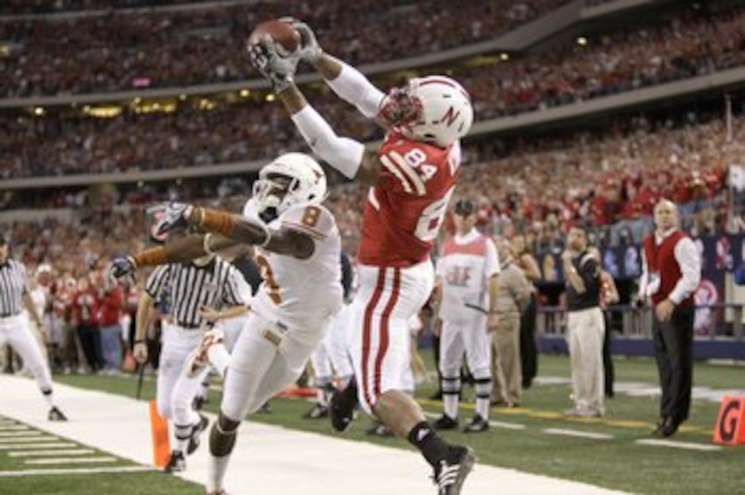 ARLINGTON, TX - DECEMBER 5: Brandon Kinnie #84 of the Nebraska Cornhuskers leaps for the catch against Chykie Brown #8 of the Texas Longhorns during Big 12 Football Championship game at Cowboys Stadium on December 5, 2009 in Arlington, Texas. (Photo by Ja
