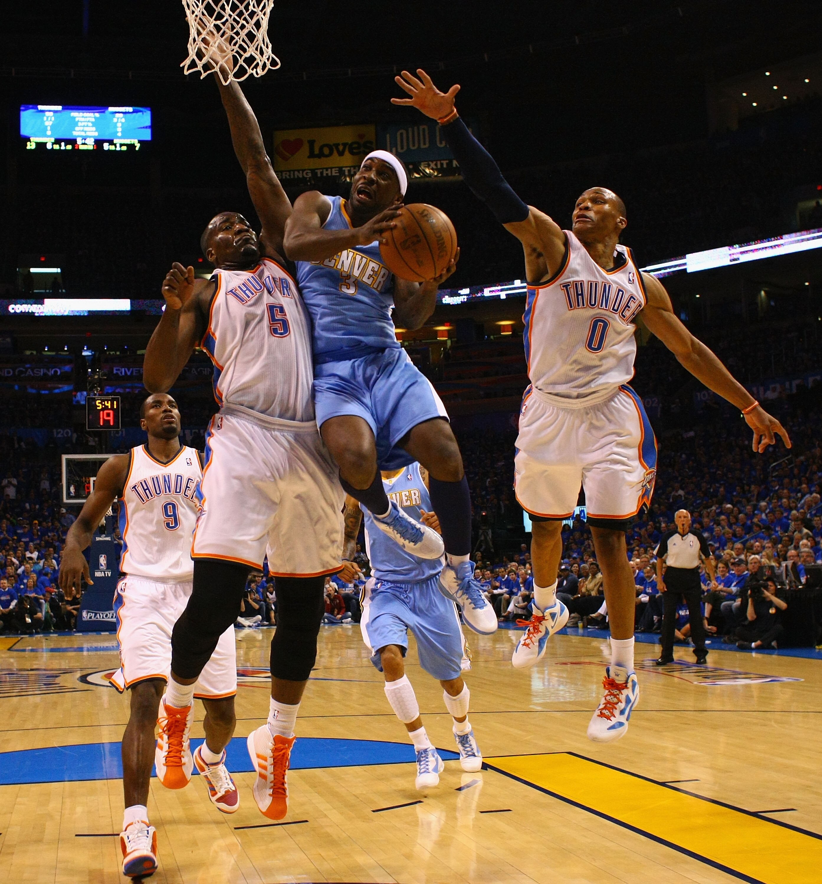 OKLAHOMA CITY, OK - APRIL 20: Ty Lawson #3 of the Denver Nuggets drives to the basket against Kendrick Perkins #5 and Russell Westbrook #0 both of the Oklahoma City Thunder in Game Two of the Western Conference Quarterfinals in the 2011 NBA Playoffs on Ap