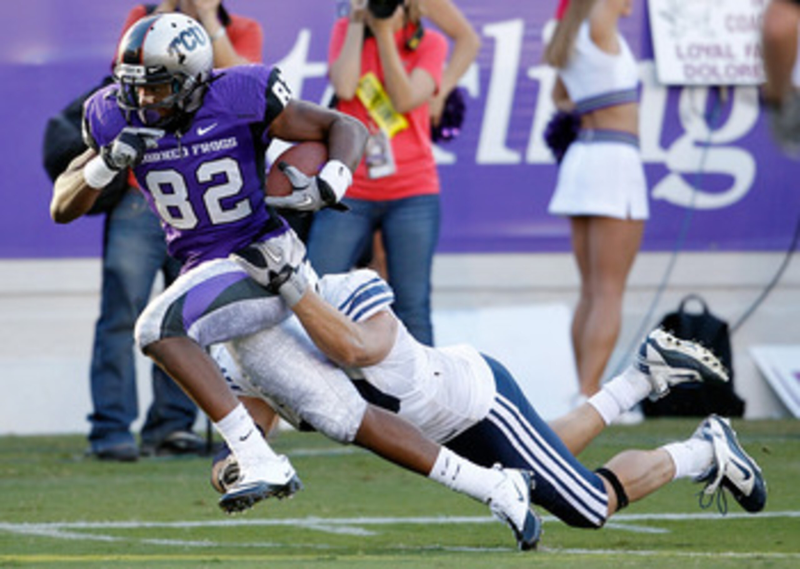 FORT WORTH, TX - OCTOBER 16:  Wide receiver Josh Boyce #82 of the TCU Horned Frogs scores a touchdown against line backer Jadon Wagner #49 the BYU Cougars at Amon G. Carter Stadium on October 16, 2010 in Fort Worth, Texas.  TCU beat BYU 31-3.  (Photo by T