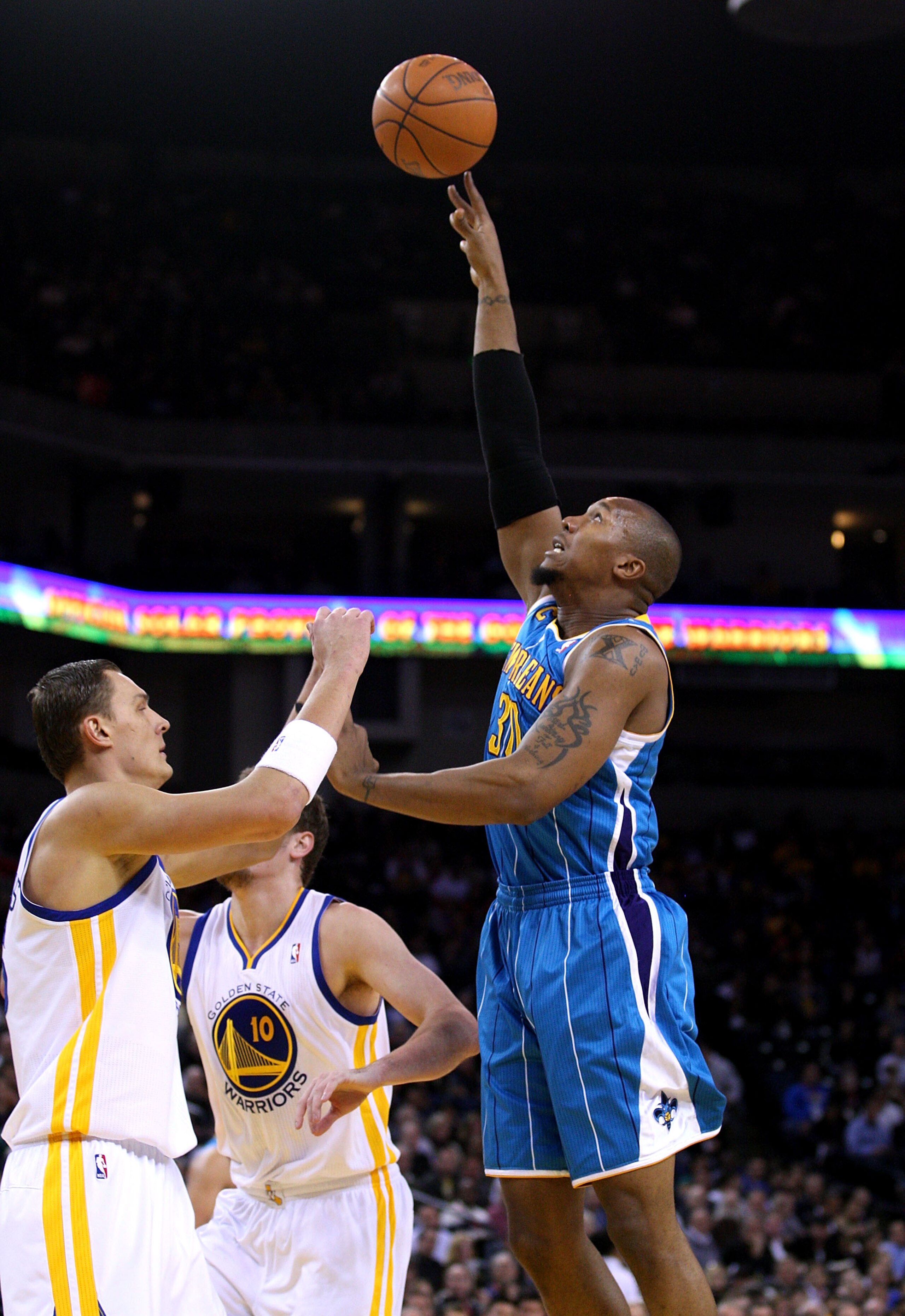 OAKLAND, CA - JANUARY 26:  David West #30 of the New Orleans Hornets shoots over Andris Biedrins #15 of the Golden State Warriors at Oracle Arena on January 26, 2011 in Oakland, California.  NOTE TO USER: User expressly acknowledges and agrees that, by do