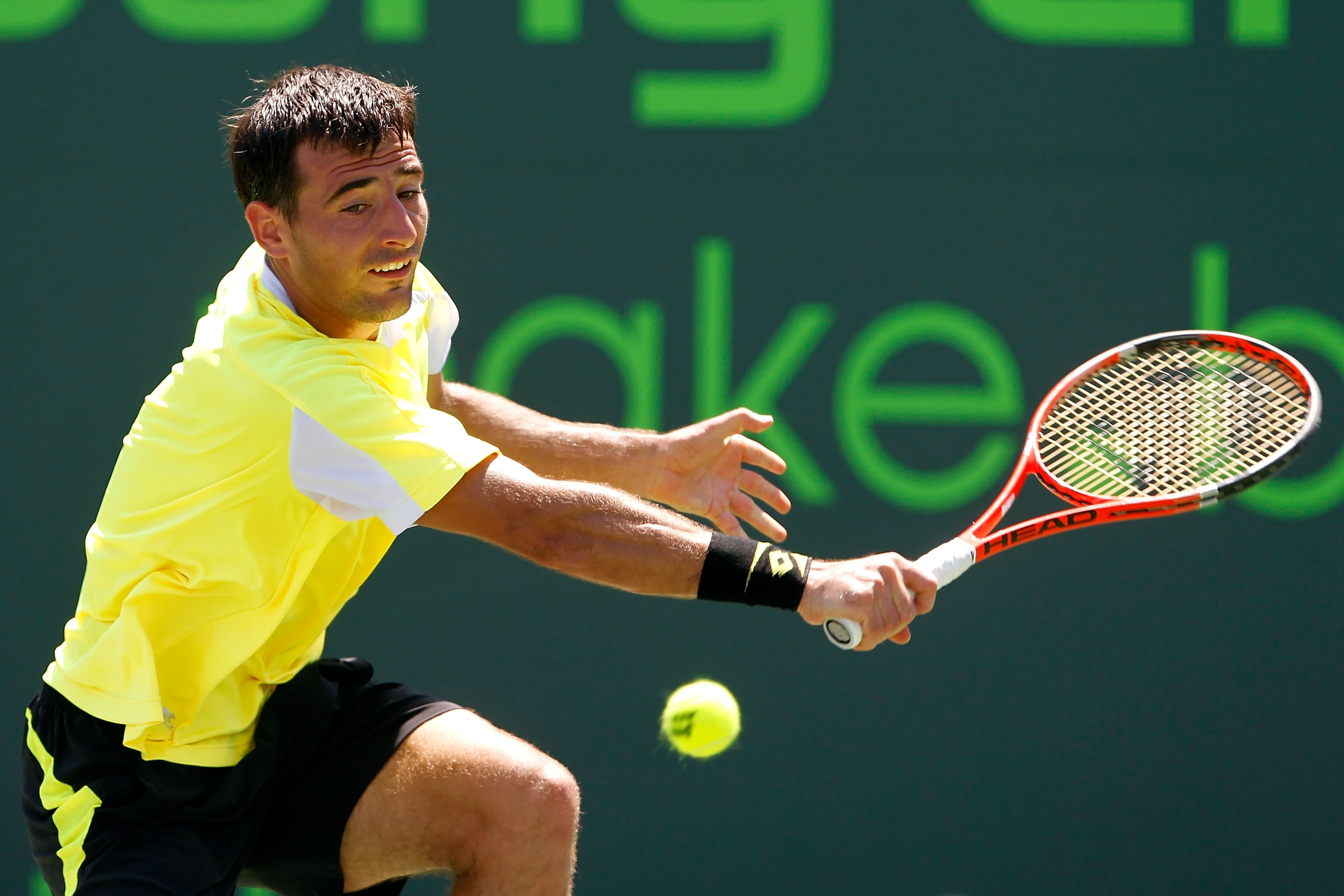 KEY BISCAYNE, FL - MARCH 25:  Ivan Dodig of Crotia hits a return against Robin Soderling of Sweden during the Sony Ericsson Open at Crandon Park Tennis Center on March 25, 2011 in Key Biscayne, Florida.  (Photo by Matthew Stockman/Getty Images)