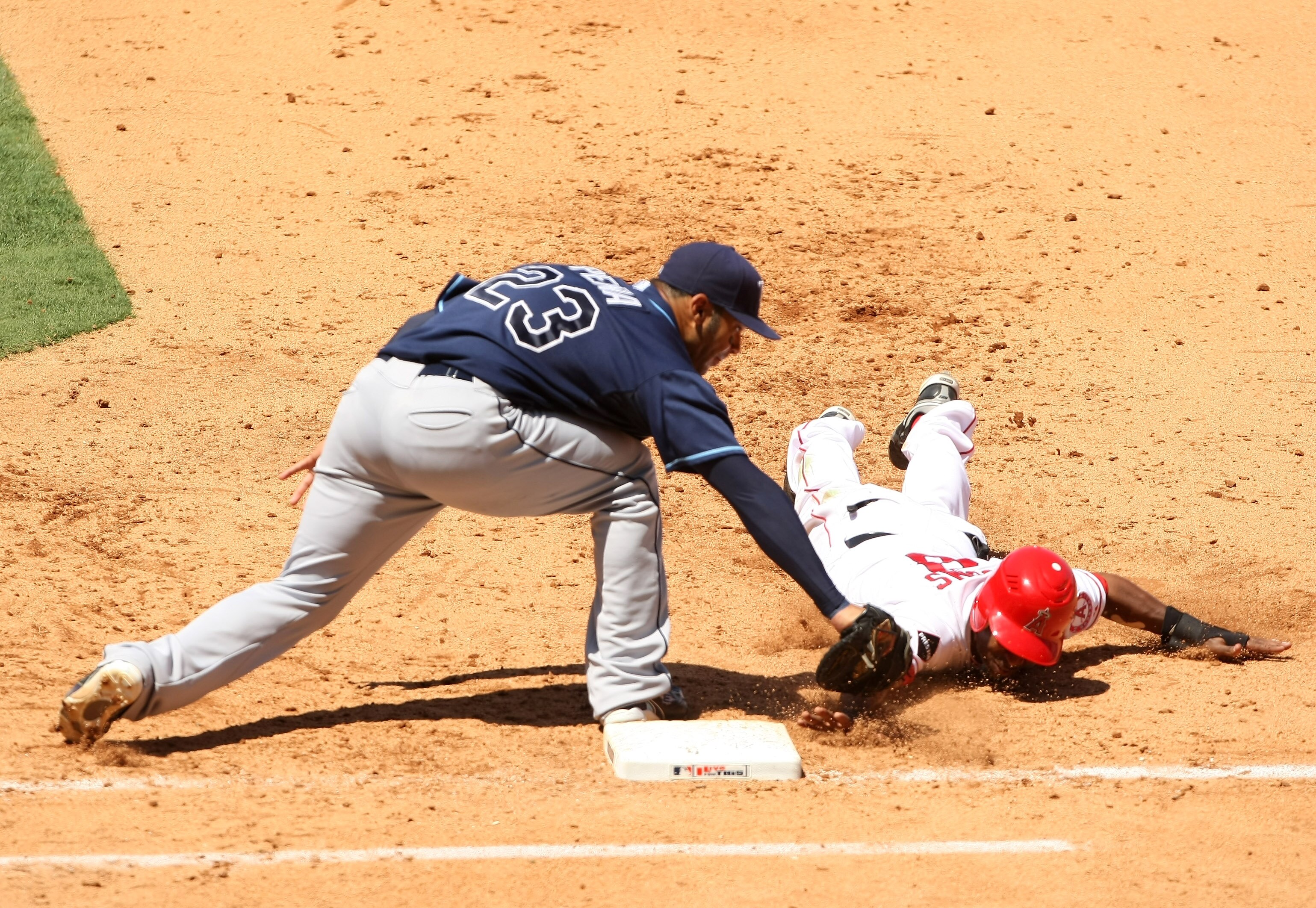 ANAHEIM, CA - AUGUST 12:  First baseman Carlos Pena #23 of the Tampa Bay Rays tags out Chone Figgins #9 of the Los Angeles Angels of Anaheim on a pickoff play in the fifth inning on August 12, 2009 at Angel Stadium in Anaheim, California.  (Photo by Steph