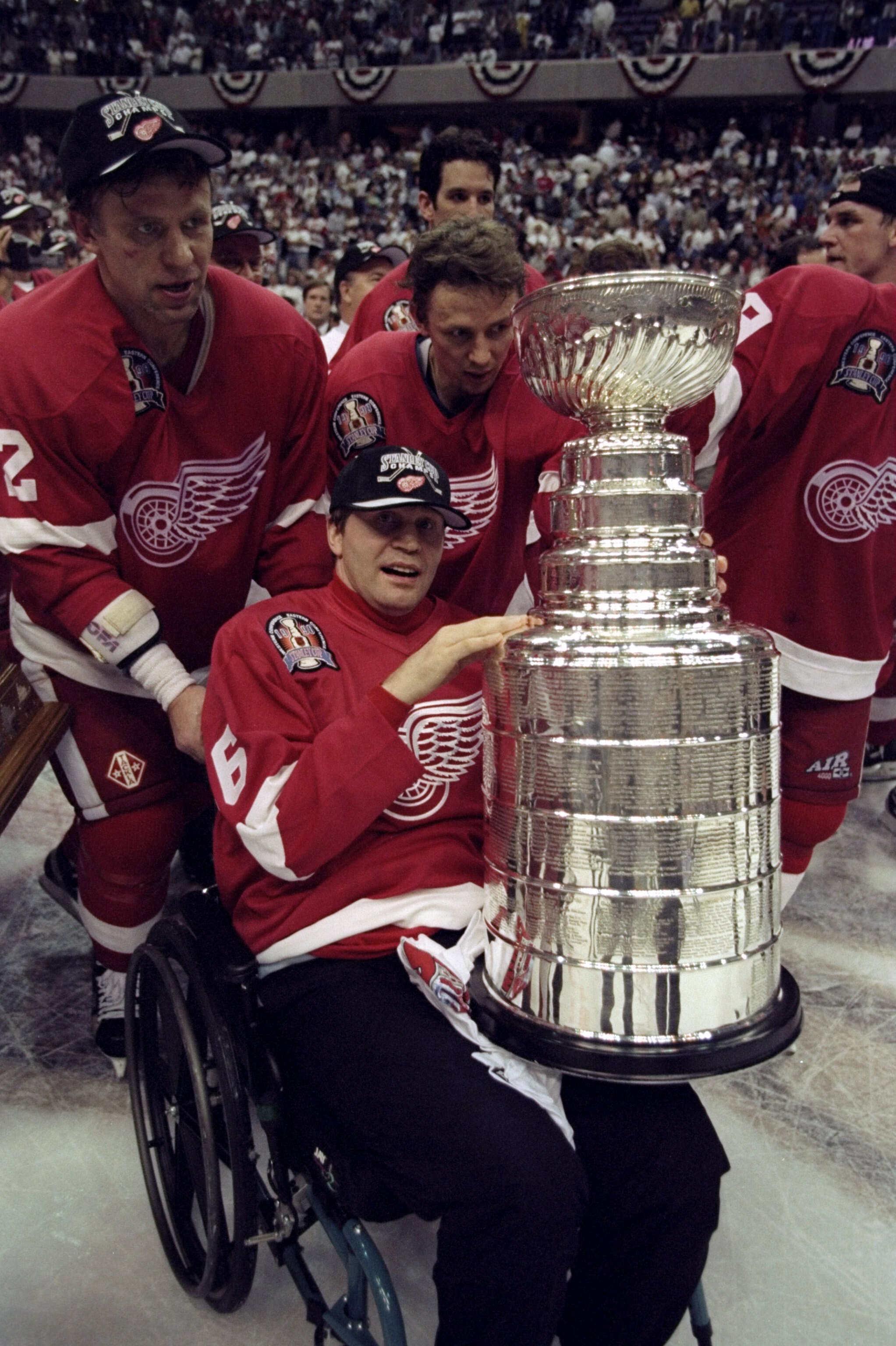 16 Jun 1998:  Former Detroit Red Wings player Vladimir Konstantinov is pushed in his wheel chair with the Stanley Cup by Viacheslav Fetisov #2 of the Red Wings following game four of the Stanley Cup Finals against the Washington Capitals at the MCI Center