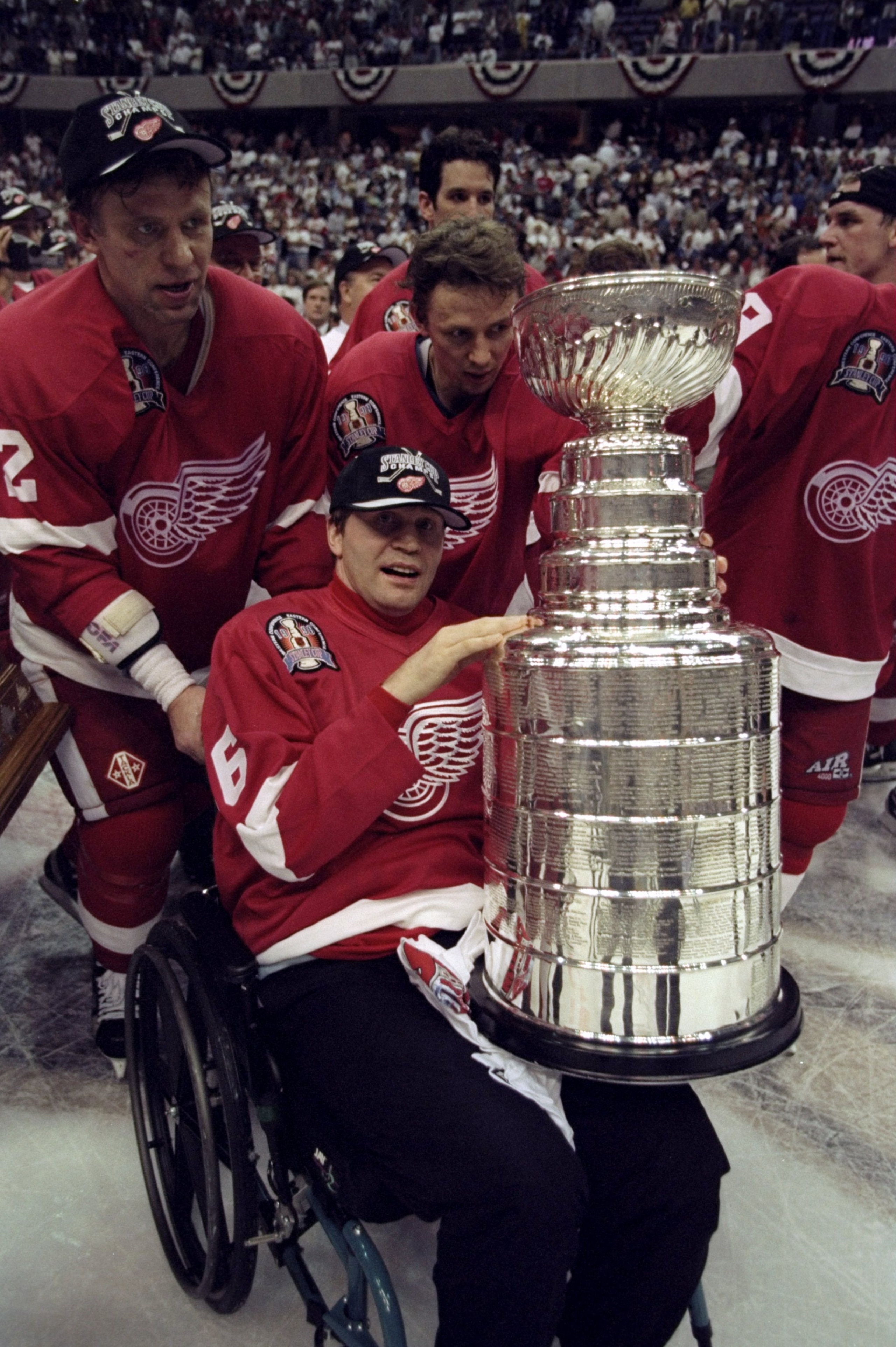 16 Jun 1998:  Former Detroit Red Wings player Vladimir Konstantinov is pushed in his wheel chair with the Stanley Cup by Viacheslav Fetisov #2 of the Red Wings following game four of the Stanley Cup Finals against the Washington Capitals at the MCI Center