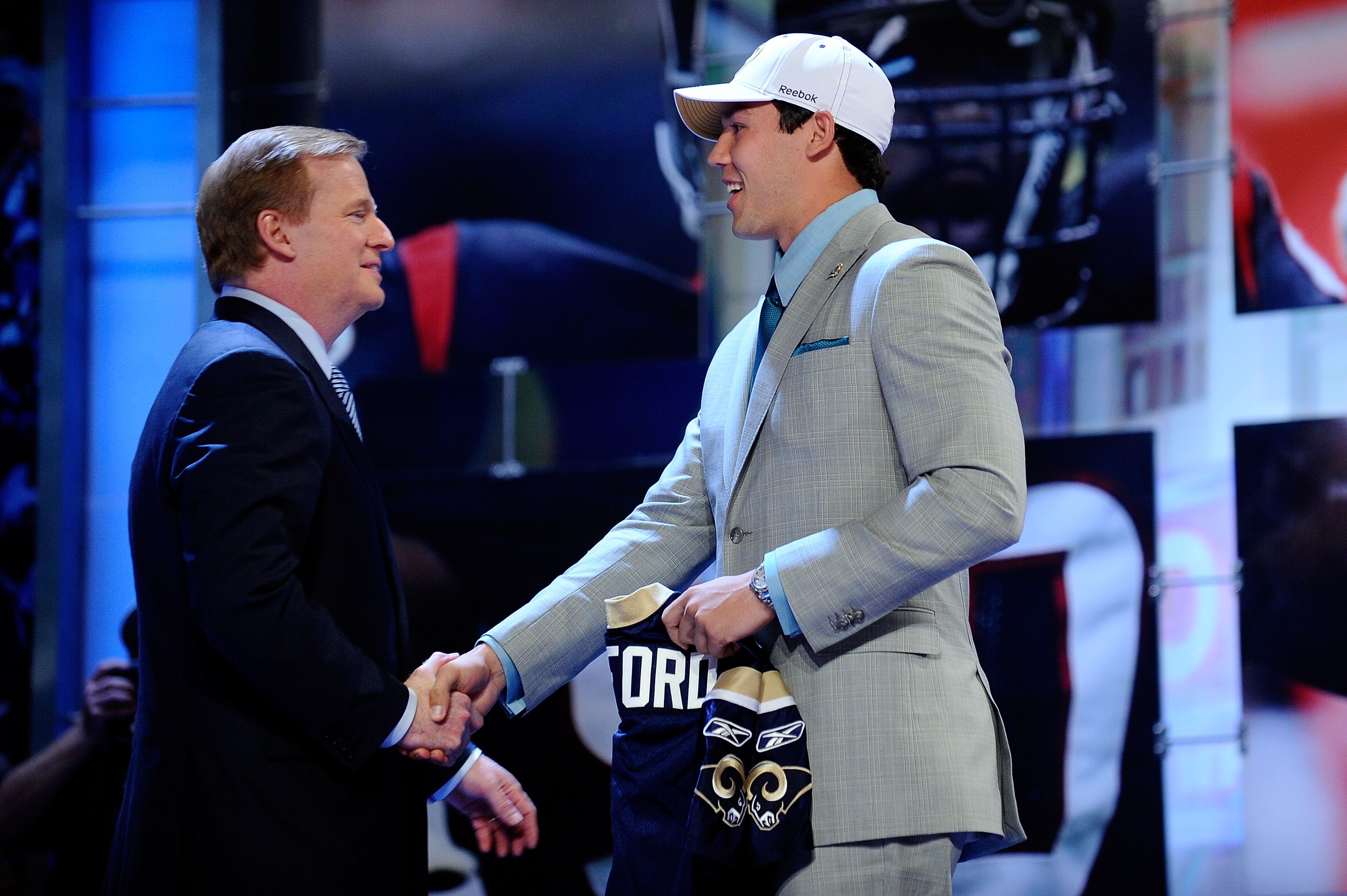 NEW YORK - APRIL 22:  Quarterback Sam Bradford (R) from the Oklahoma Sooners greets NFL Commissioner Roger Goodell after Bradford was selected number 1 overall by the St. Louis Rams during the first round of the 2010 NFL Draft at Radio City Music Hall on